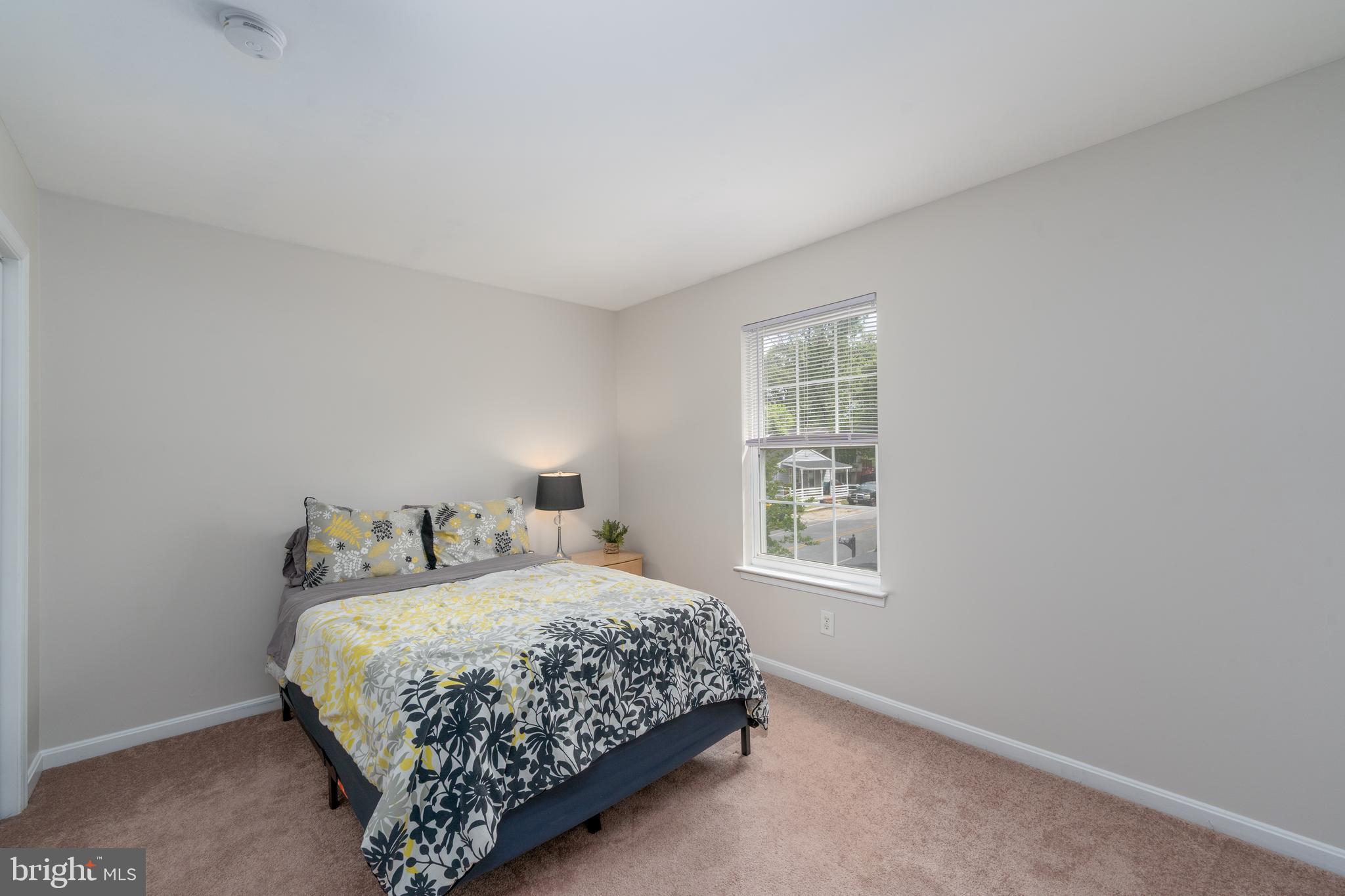 7815 Outing Avenue Pasadena, MD 21122 - Photo 20 of 37 a bedroom with a bed next to a window