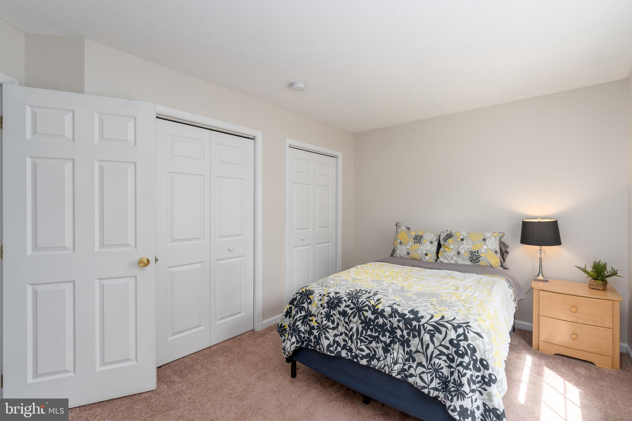 7815 Outing Avenue Pasadena, MD 21122 - Photo 21 of 37 a bedroom with a bed and a table