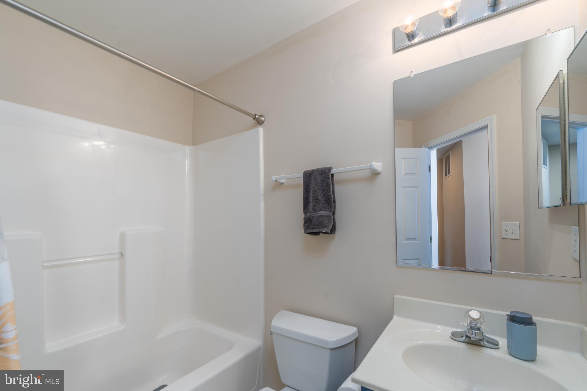 7815 Outing Avenue Pasadena, MD 21122 - Photo 24 of 37 a bathroom with a sink a toilet and shower