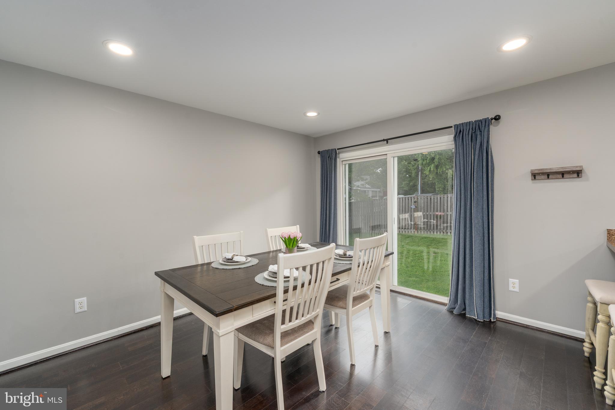 7815 Outing Avenue Pasadena, MD 21122 - Photo 6 of 37 a view of a dining room with furniture and wooden floor
