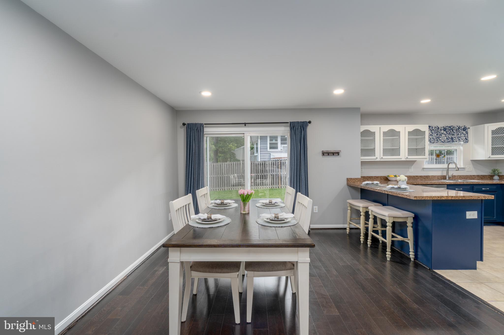 7815 Outing Avenue Pasadena, MD 21122 - Photo 7 of 37 a dining room with furniture and wooden floor