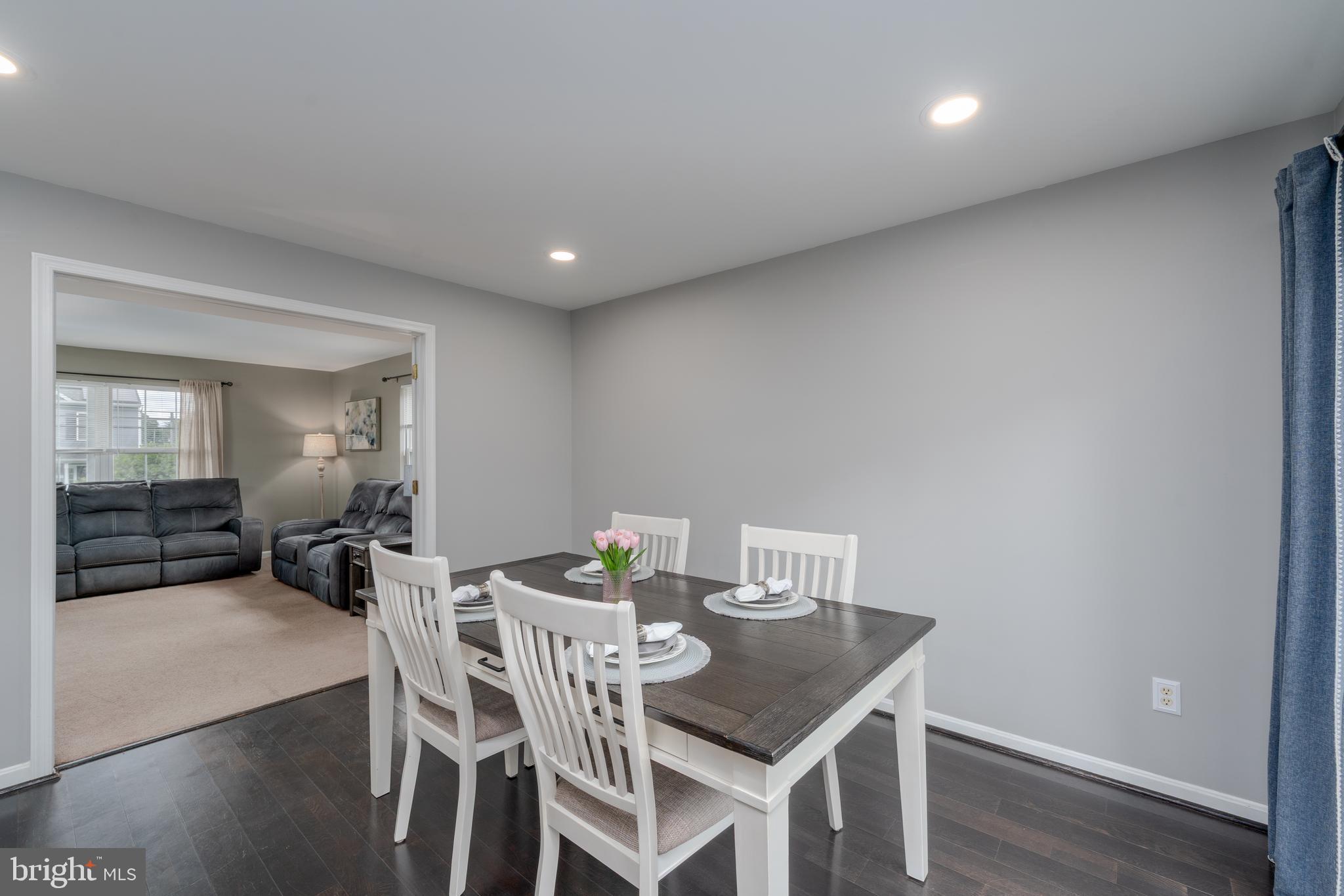 7815 Outing Avenue Pasadena, MD 21122 - Photo 8 of 37 a view of a dining room with furniture and wooden floor