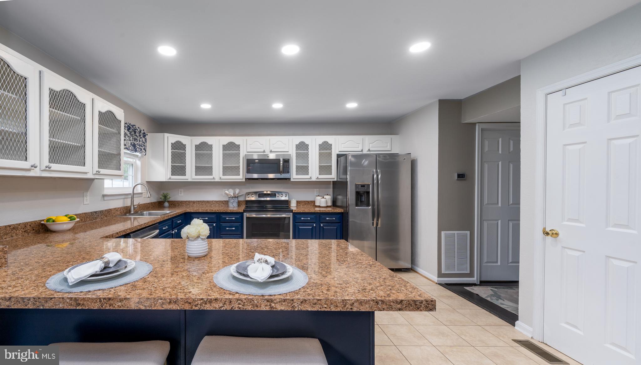 7815 Outing Avenue Pasadena, MD 21122 - Photo 10 of 37 a kitchen with granite countertop lots of wooden furniture