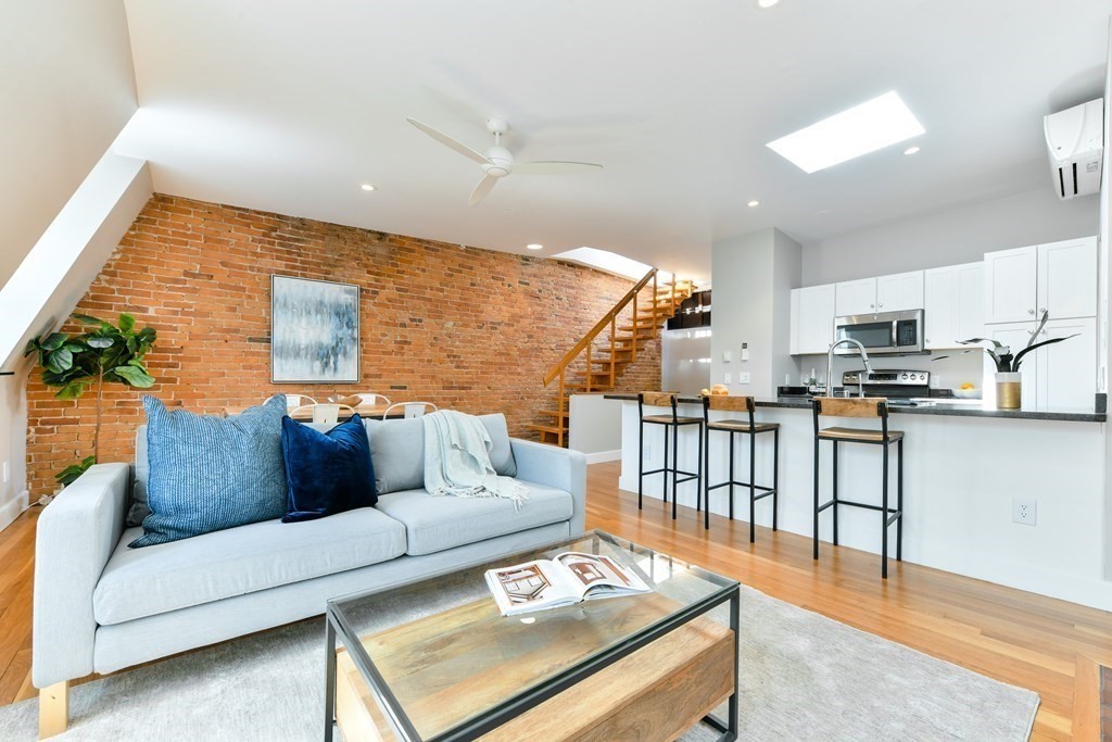 27 Concord Square, Unit 4 Boston, MA 02118 - Photo 5 of 8 a living room with furniture and kitchen view