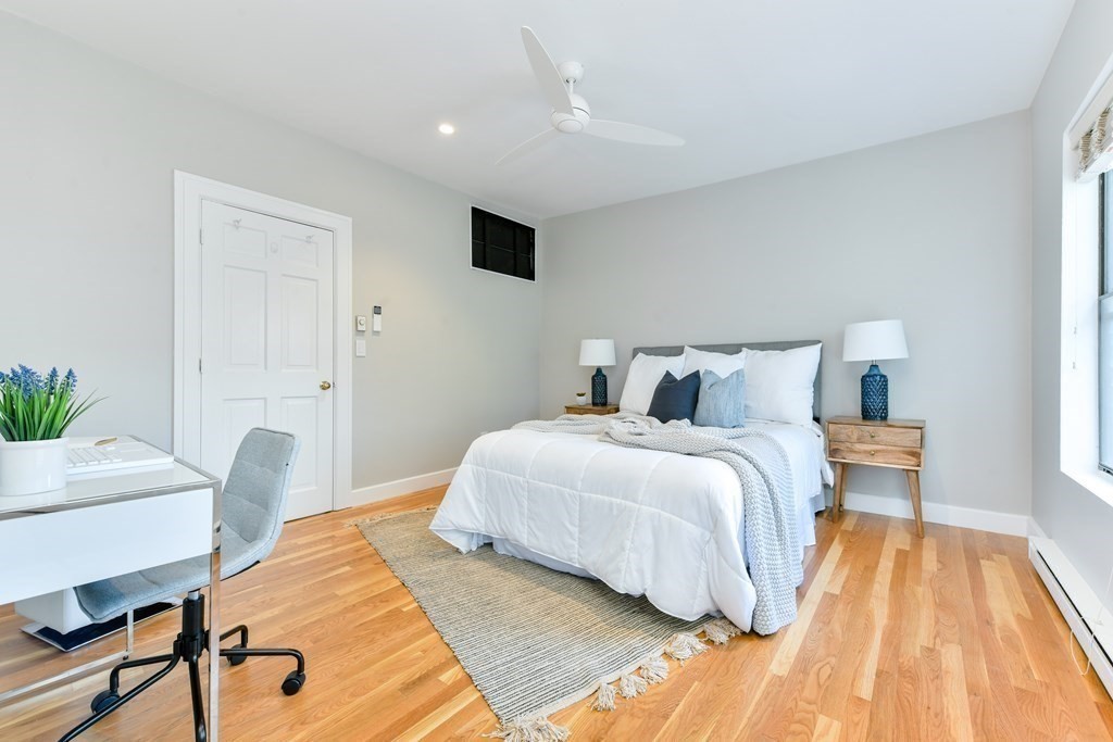 27 Concord Square, Unit 4 Boston, MA 02118 - Photo 6 of 8 a bedroom with a bed and a table in it