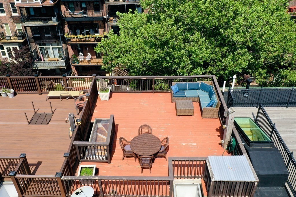 27 Concord Square, Unit 4 Boston, MA 02118 - Photo 8 of 8 a view of roof deck with patio table and chairs