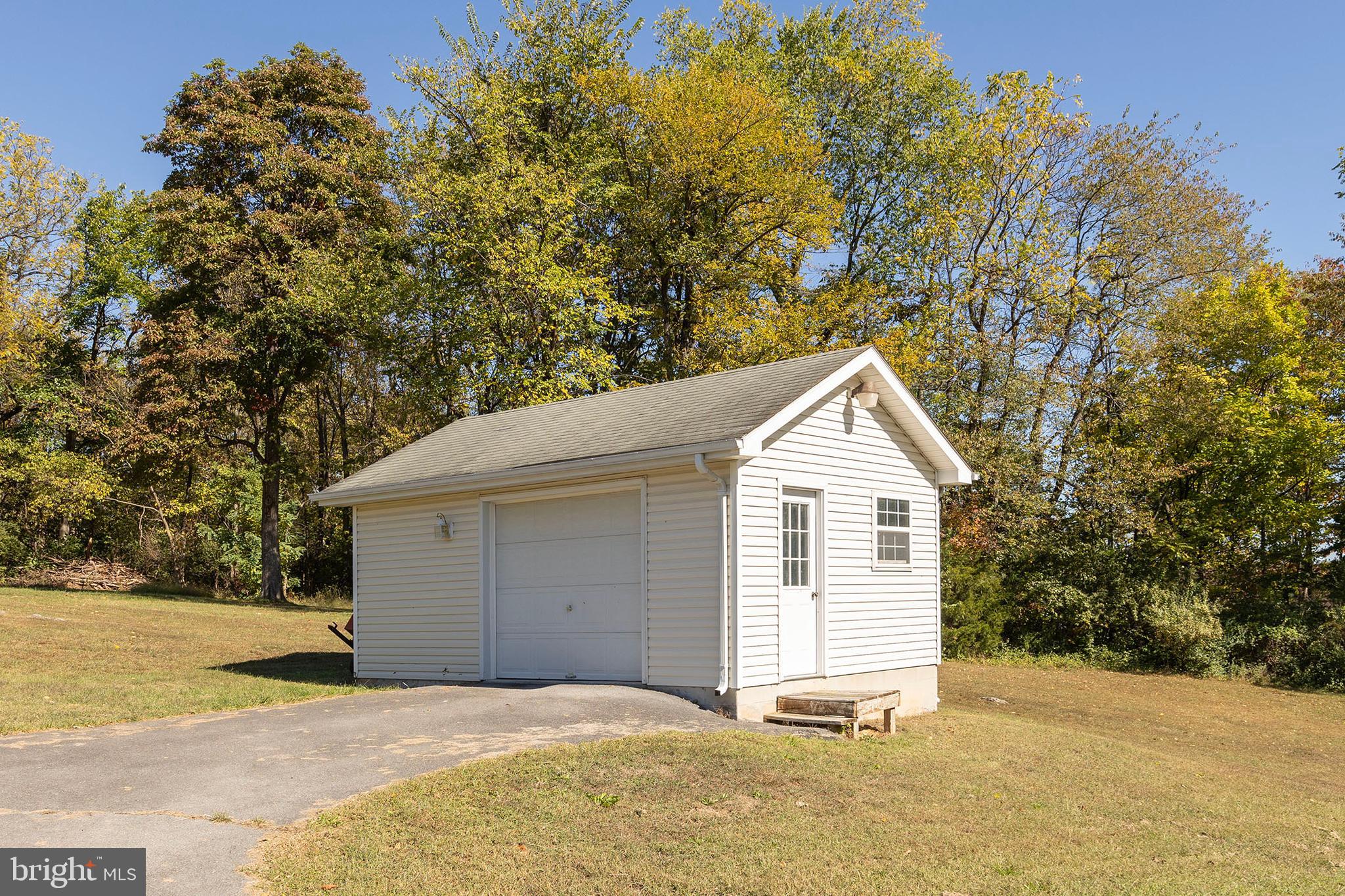 1039 Hiatt Road Clear Brook, VA 22624 - Photo 52 of 55 a front view of a house with a yard and garage
