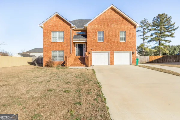 a front view of a house with a yard