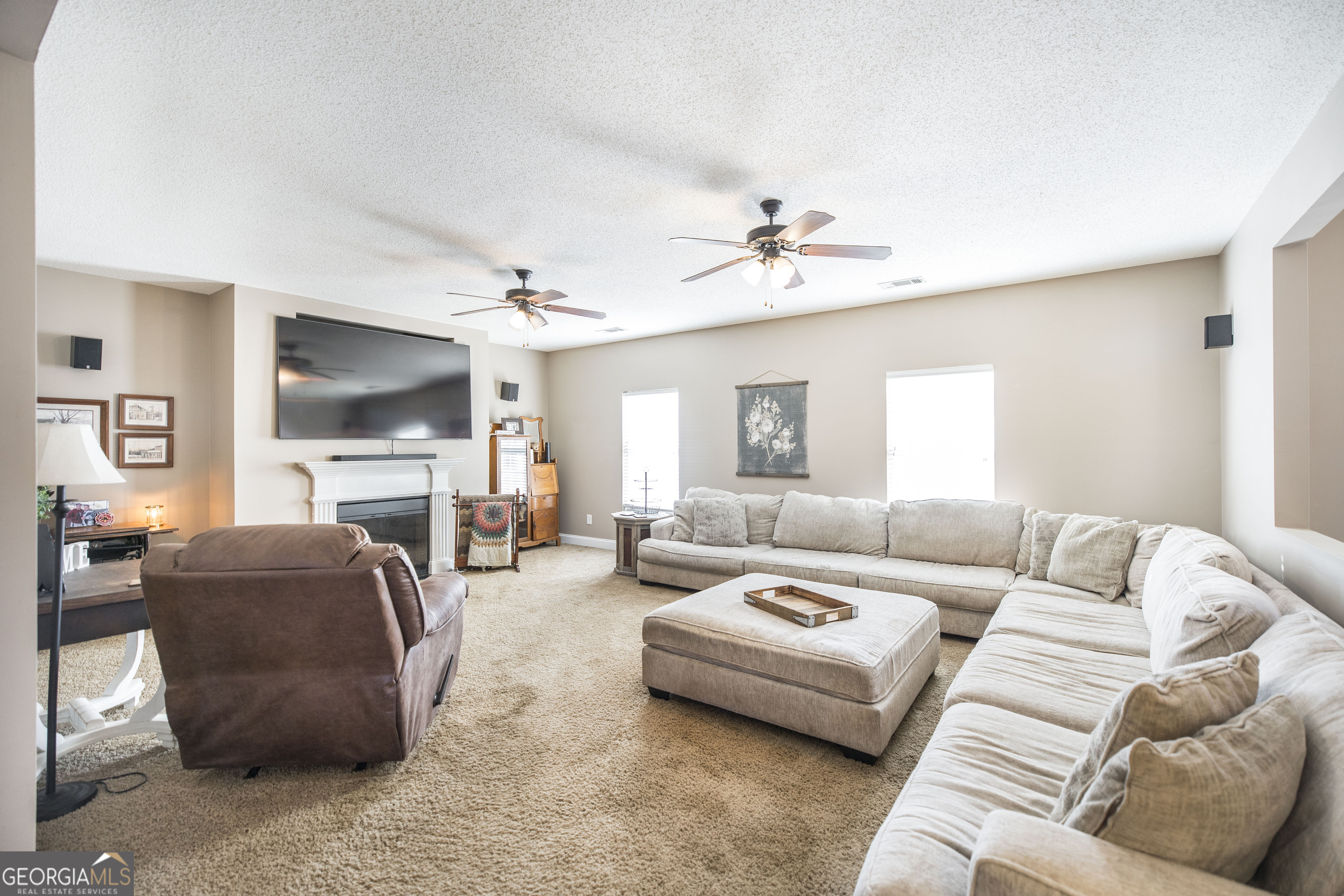 303 Rose Pointe Court Bonaire, GA 31005 - Photo 12 of 31 a living room with furniture a fireplace and a flat screen tv