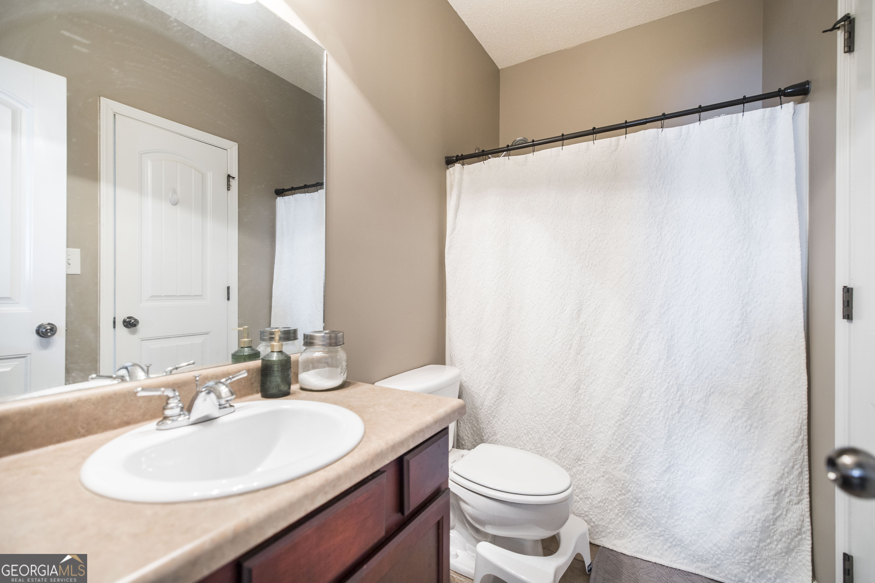 303 Rose Pointe Court Bonaire, GA 31005 - Photo 14 of 31 a bathroom with a sink and a mirror