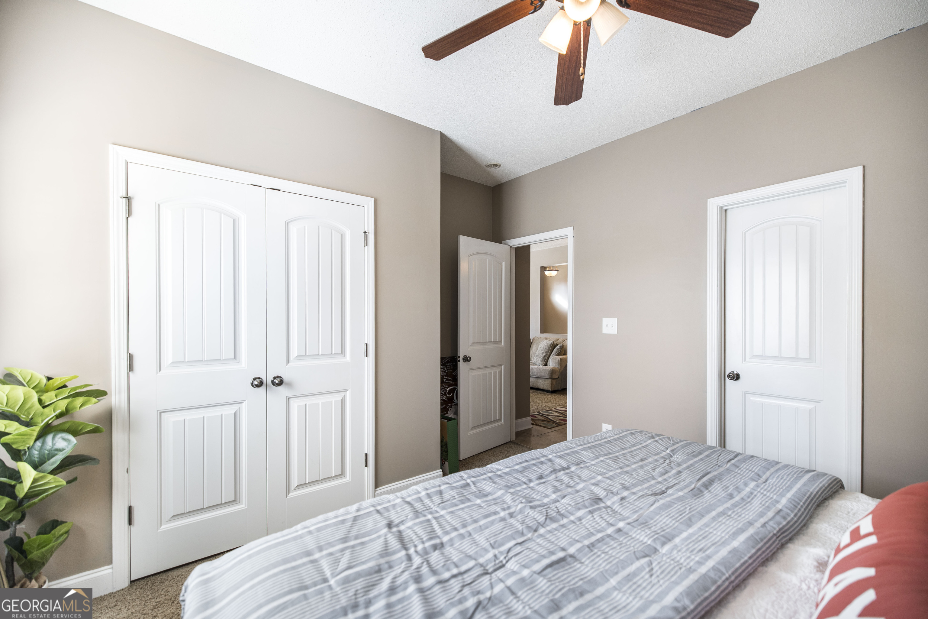 303 Rose Pointe Court Bonaire, GA 31005 - Photo 16 of 31 a bedroom with a bed and a chandelier