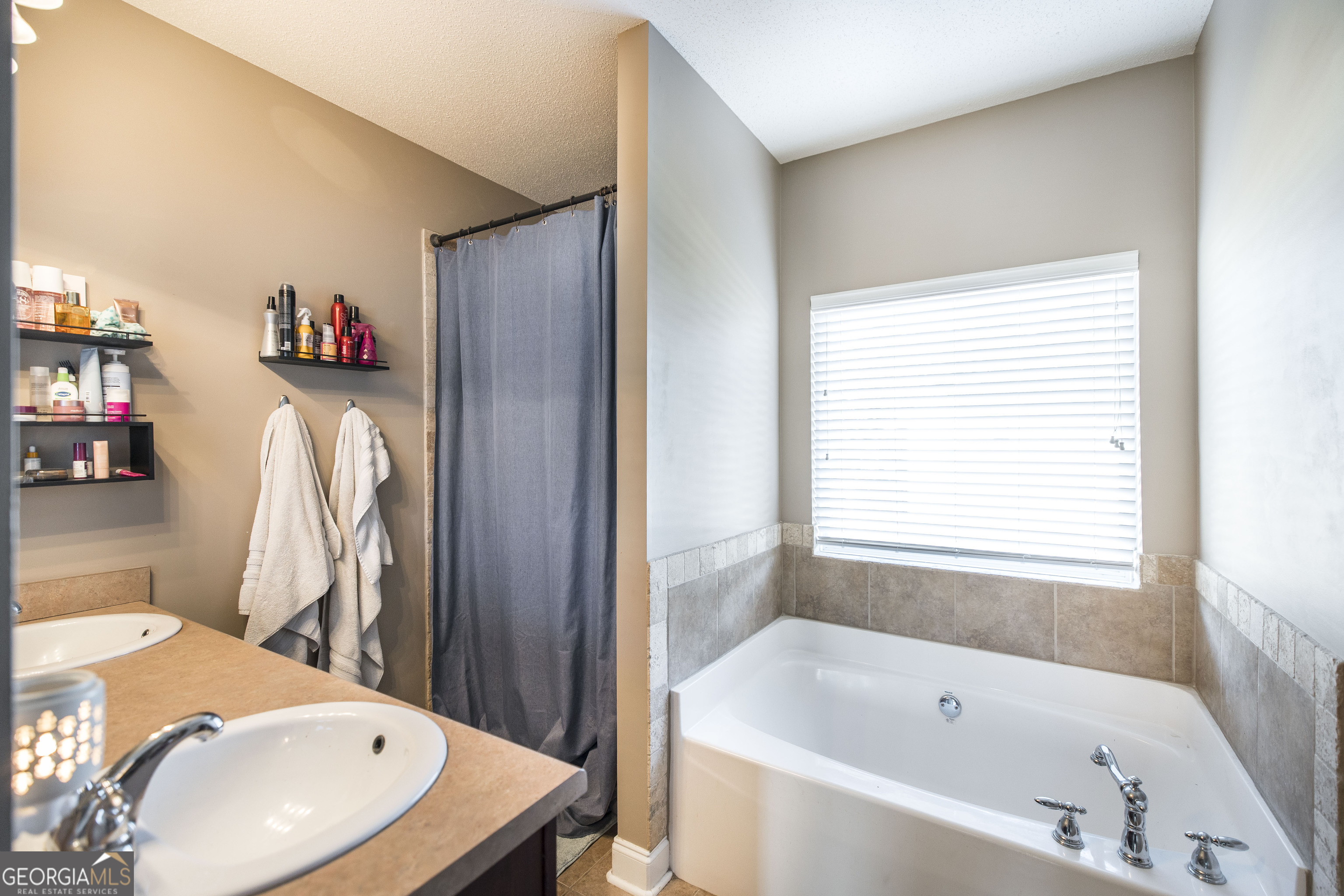 303 Rose Pointe Court Bonaire, GA 31005 - Photo 19 of 31 a bathroom with a tub a sink and a shower