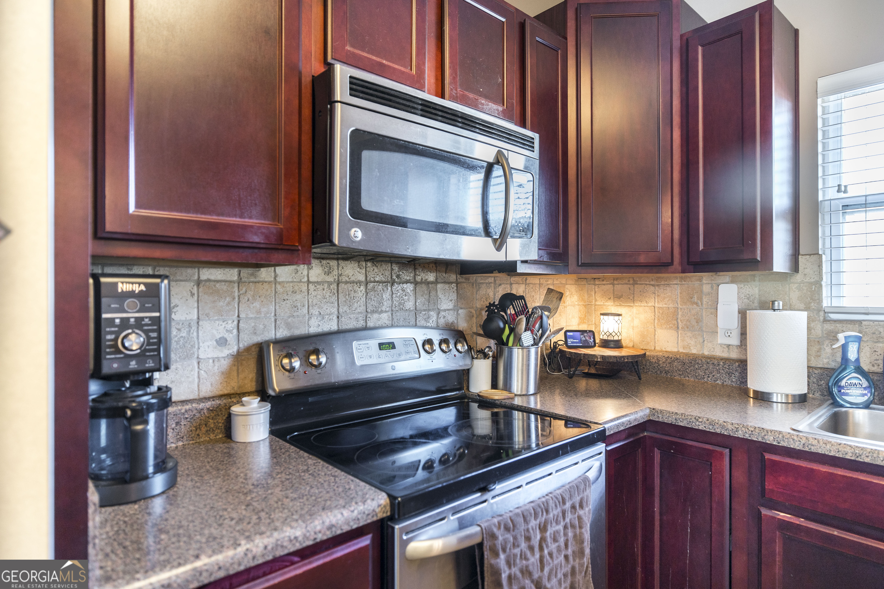 303 Rose Pointe Court Bonaire, GA 31005 - Photo 8 of 31 a kitchen with stainless steel appliances granite countertop a stove a microwave and cabinets