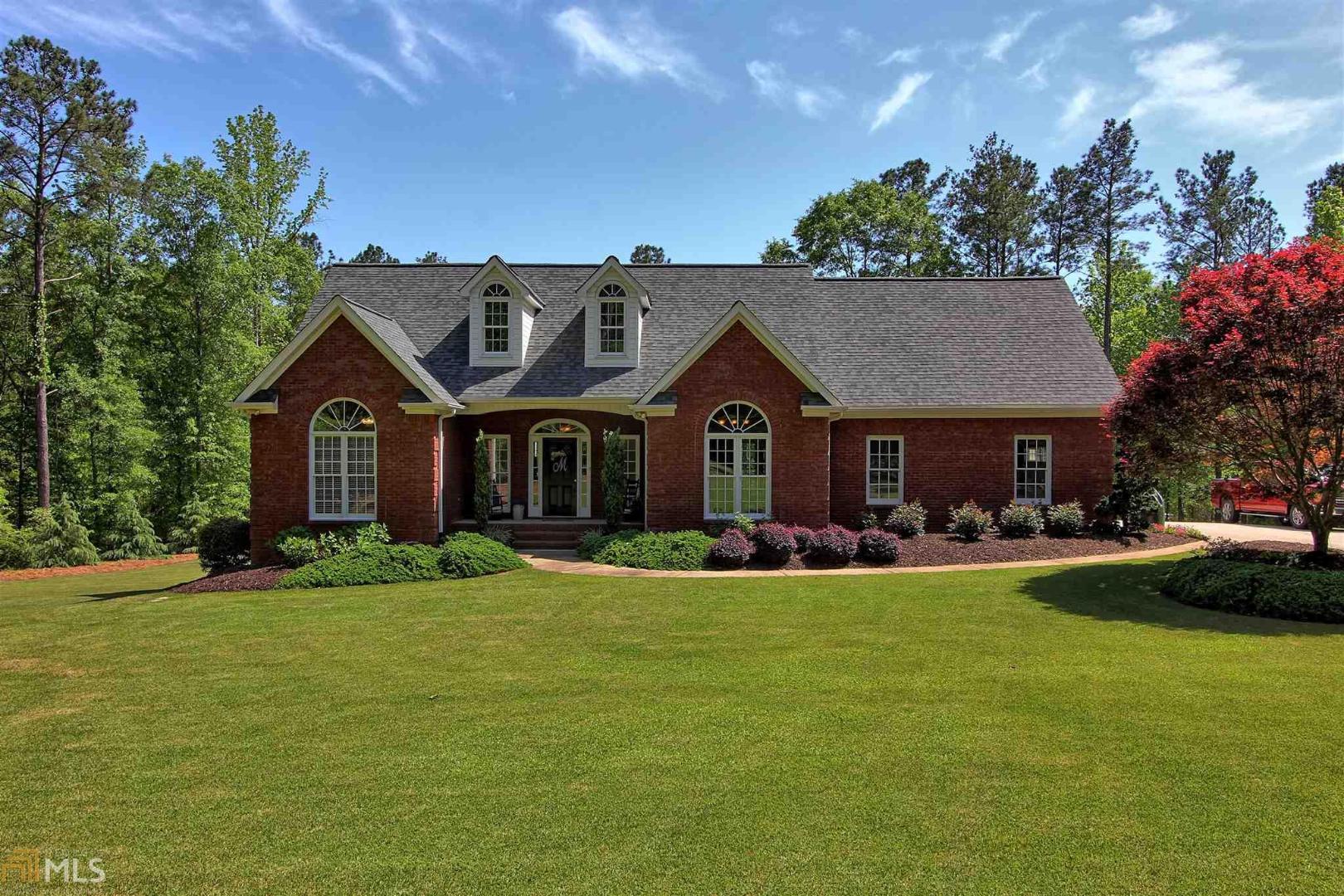 1775 Locust Grove Road Griffin, GA 30223 - Photo 1 of 1 a front view of a house with a garden and yard
