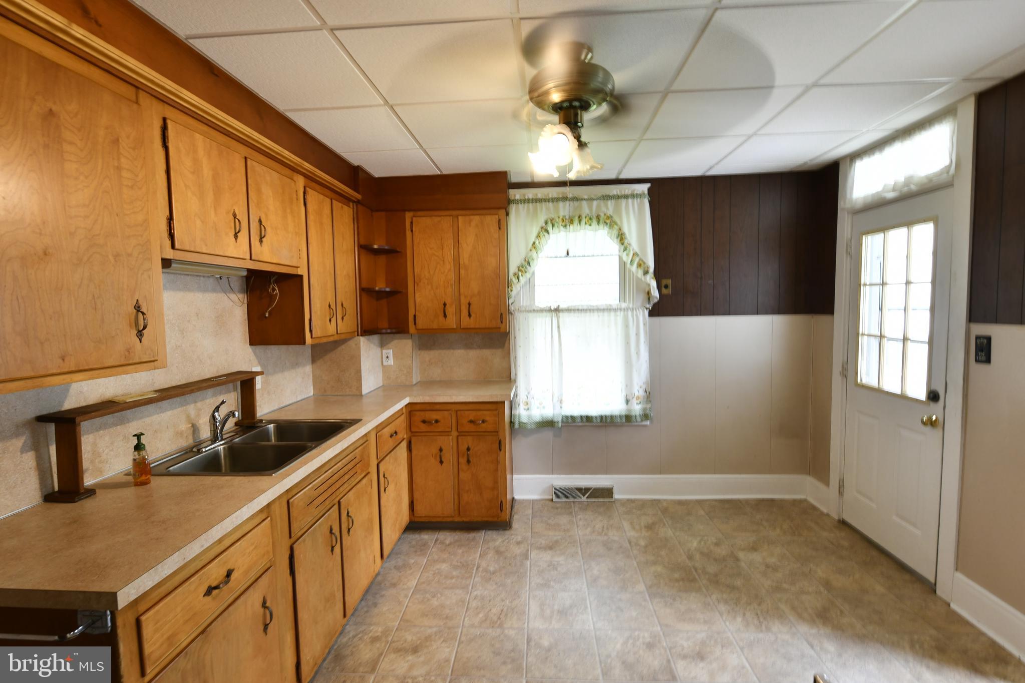 188 North Main Street Manheim, PA 17545 - Photo 4 of 19 a kitchen with stainless steel appliances granite countertop a sink a stove cabinets counter space and a window
