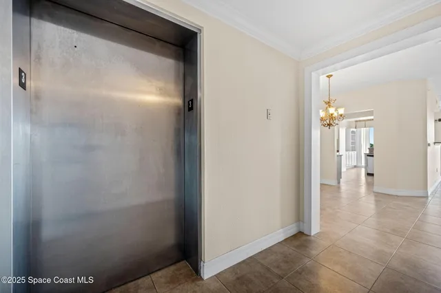 a view of a chandelier in big room and chandelier fan
