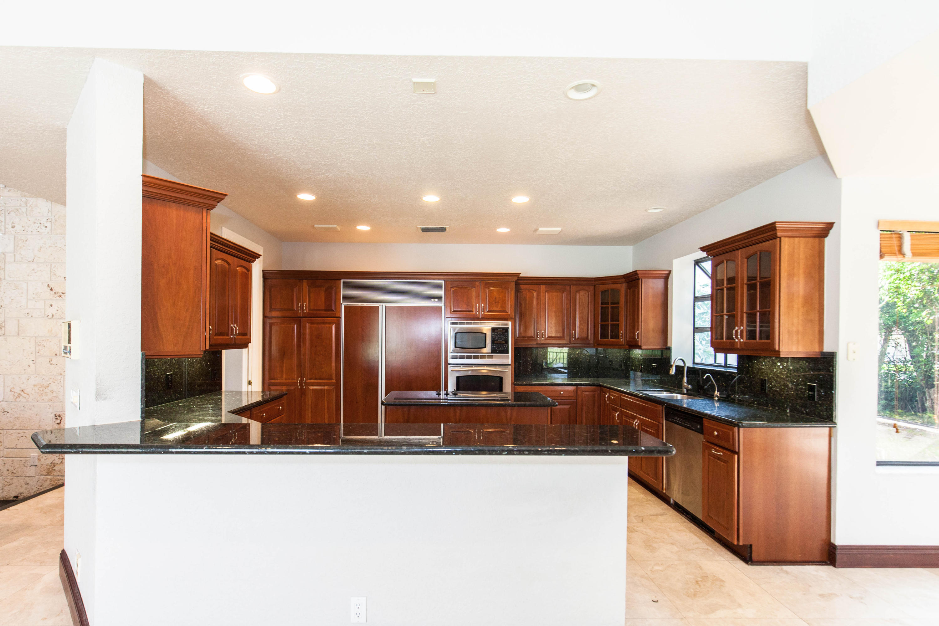 6087 Northwest 23rd Terrace Boca Raton, FL 33496 - Photo 11 of 64 a large kitchen with stainless steel appliances a large counter top