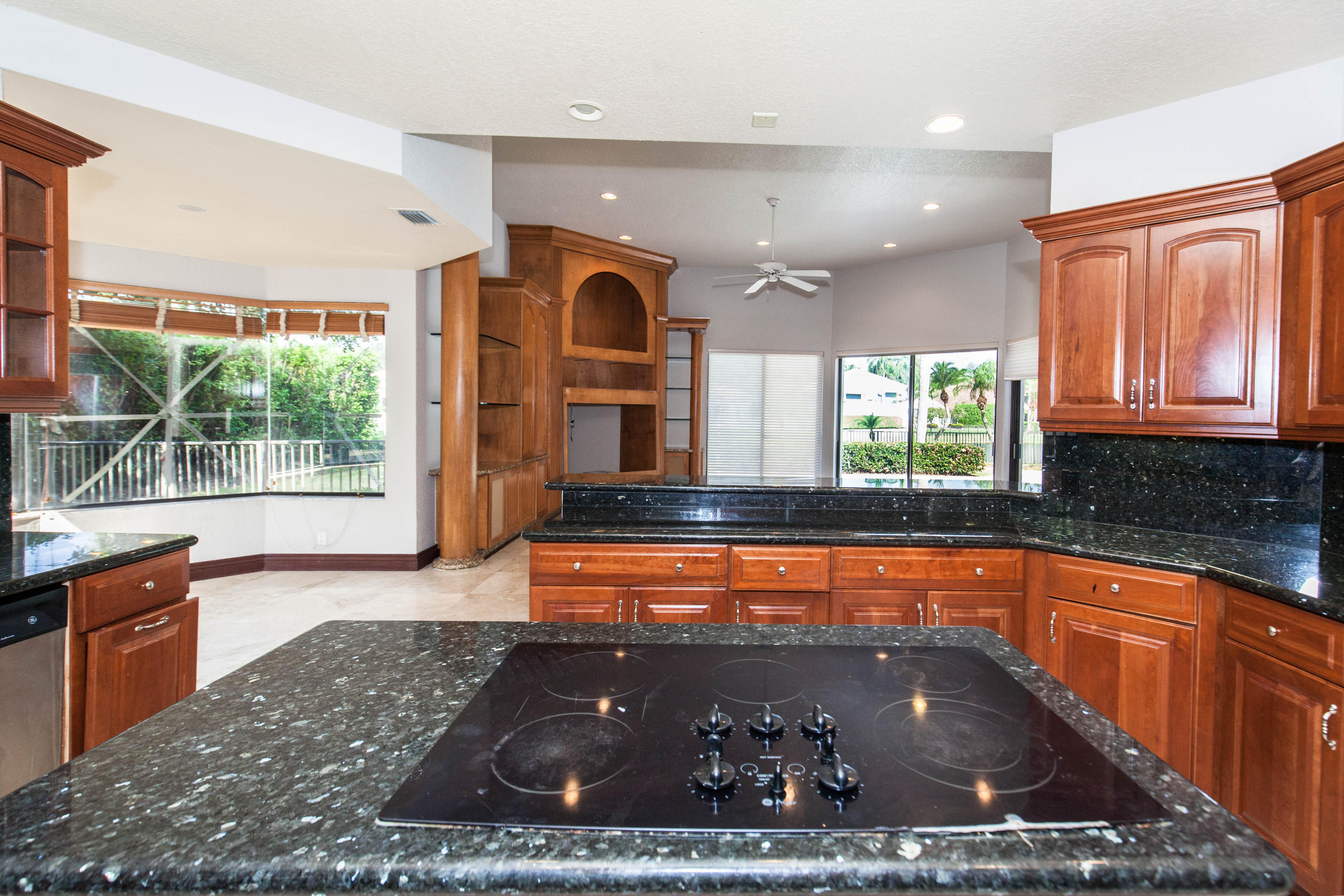 6087 Northwest 23rd Terrace Boca Raton, FL 33496 - Photo 14 of 64 a large kitchen with kitchen island granite countertop a large window