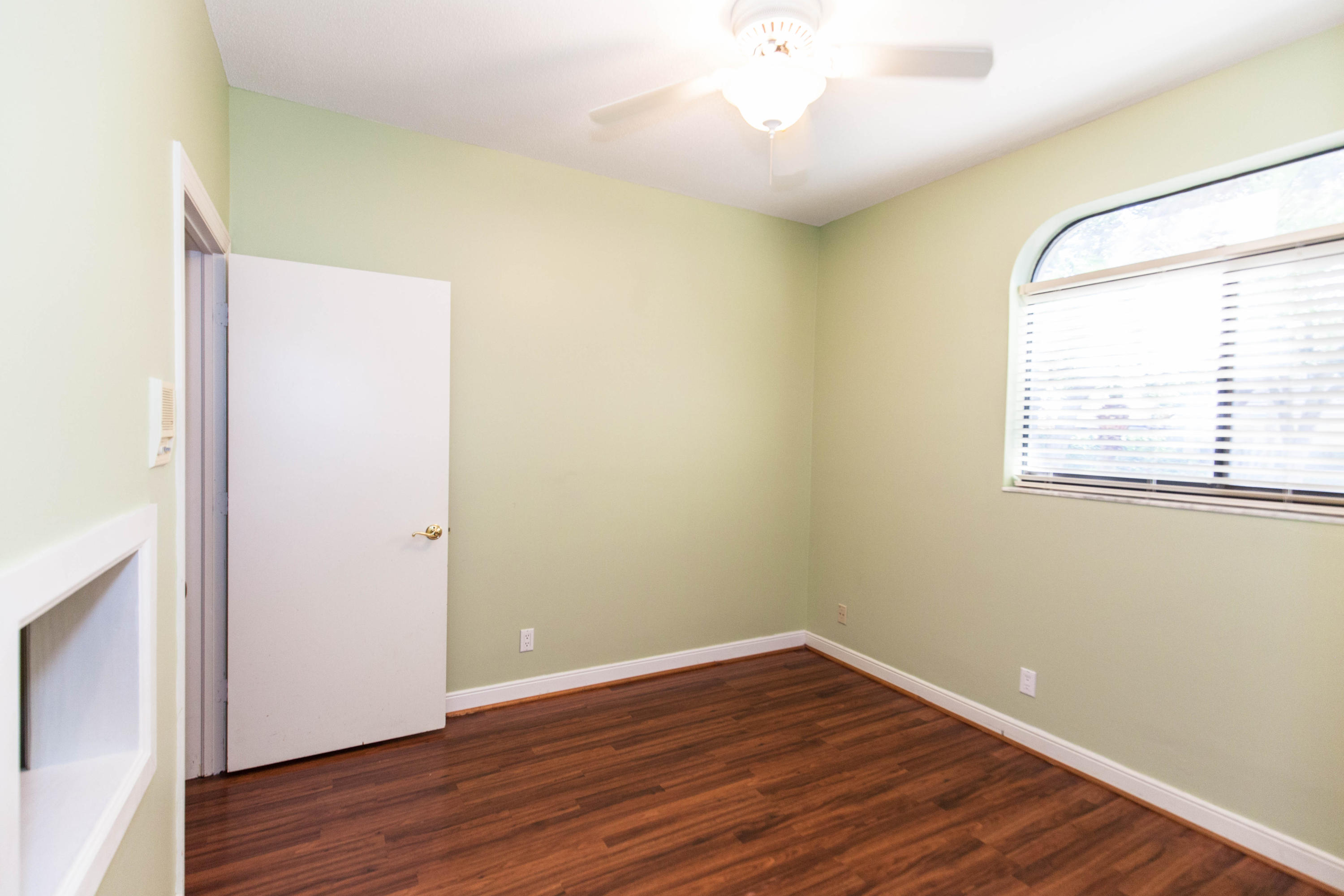 6087 Northwest 23rd Terrace Boca Raton, FL 33496 - Photo 24 of 64 an empty room with wooden floor and windows