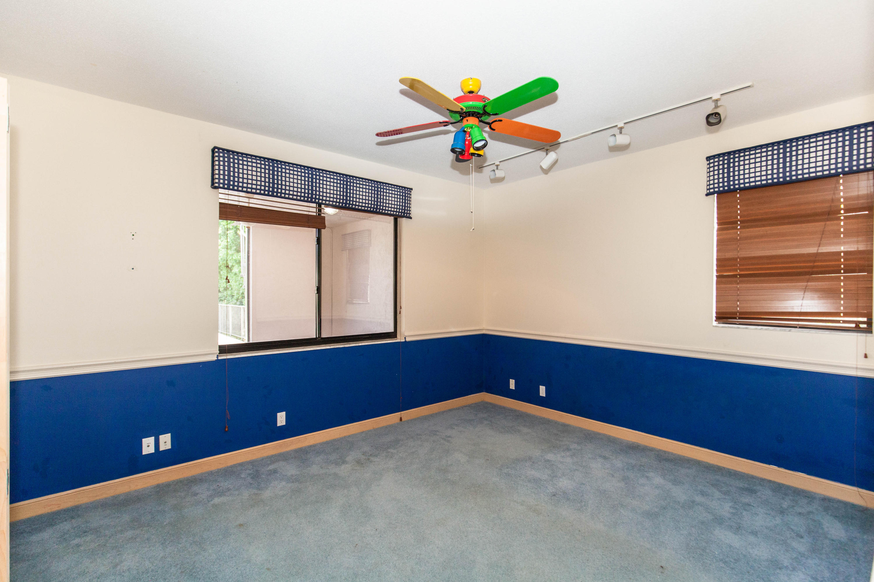 6087 Northwest 23rd Terrace Boca Raton, FL 33496 - Photo 29 of 64 an empty room with windows and flowers