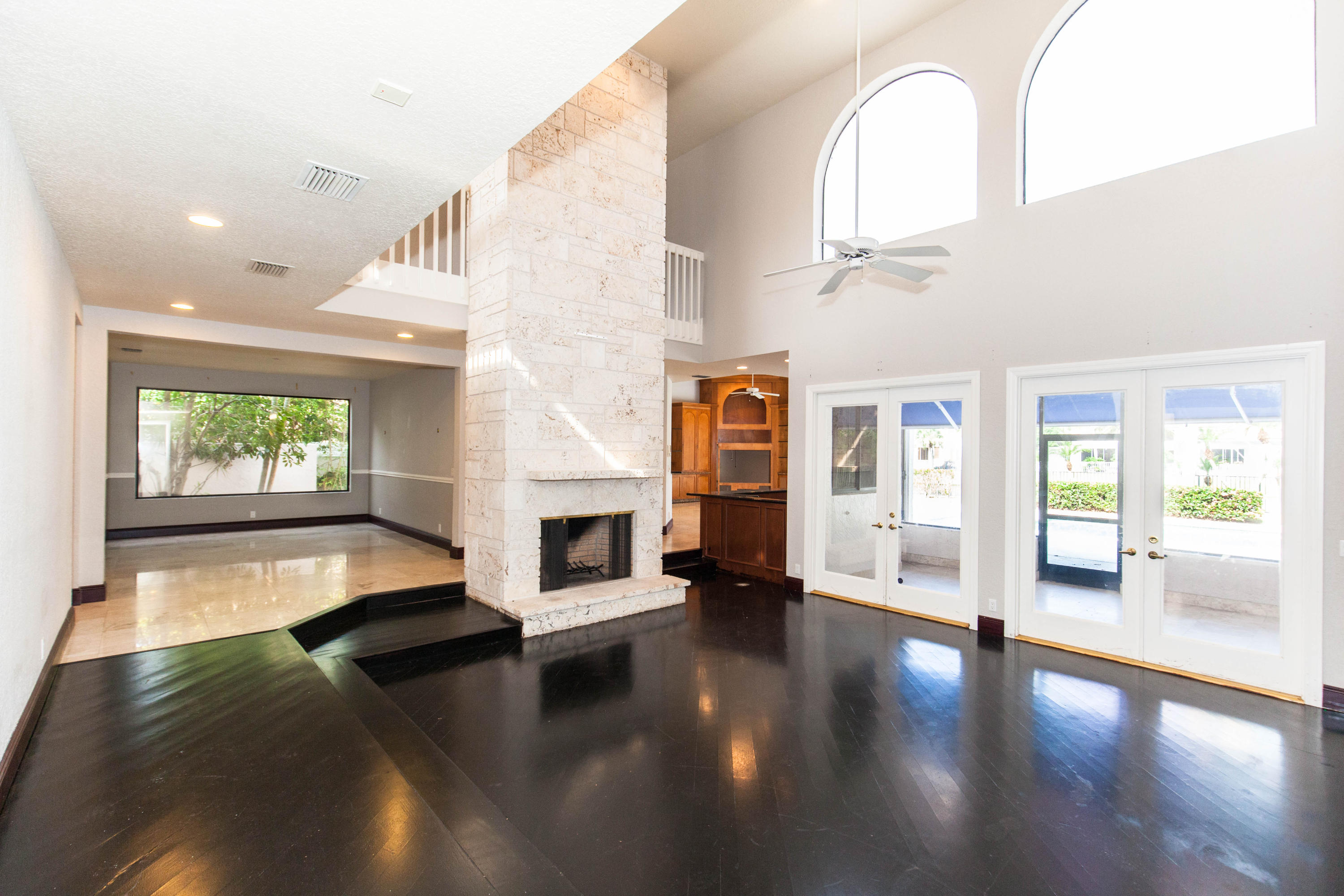 6087 Northwest 23rd Terrace Boca Raton, FL 33496 - Photo 4 of 64 a view of an entryway with floor to ceiling windows and a kitchen