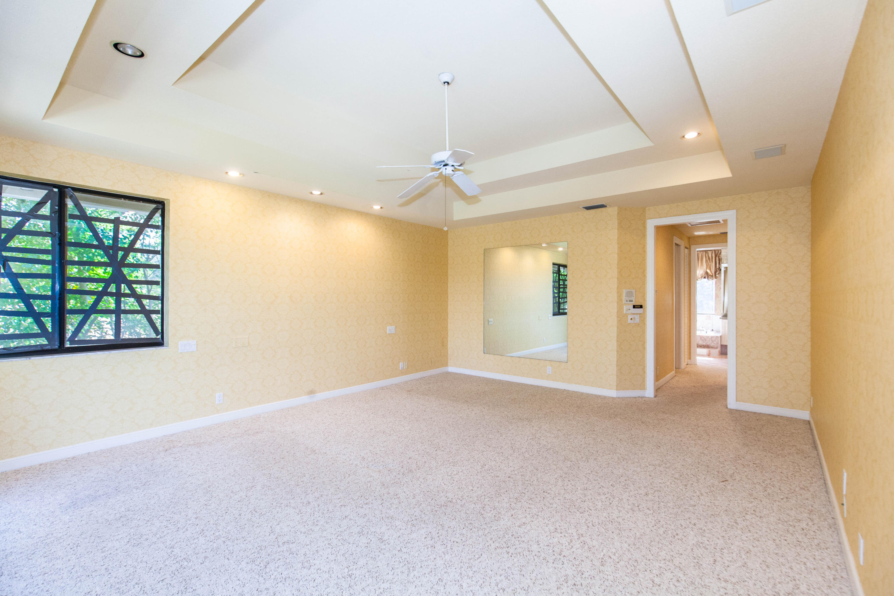 6087 Northwest 23rd Terrace Boca Raton, FL 33496 - Photo 41 of 64 an empty room with windows and cabinet