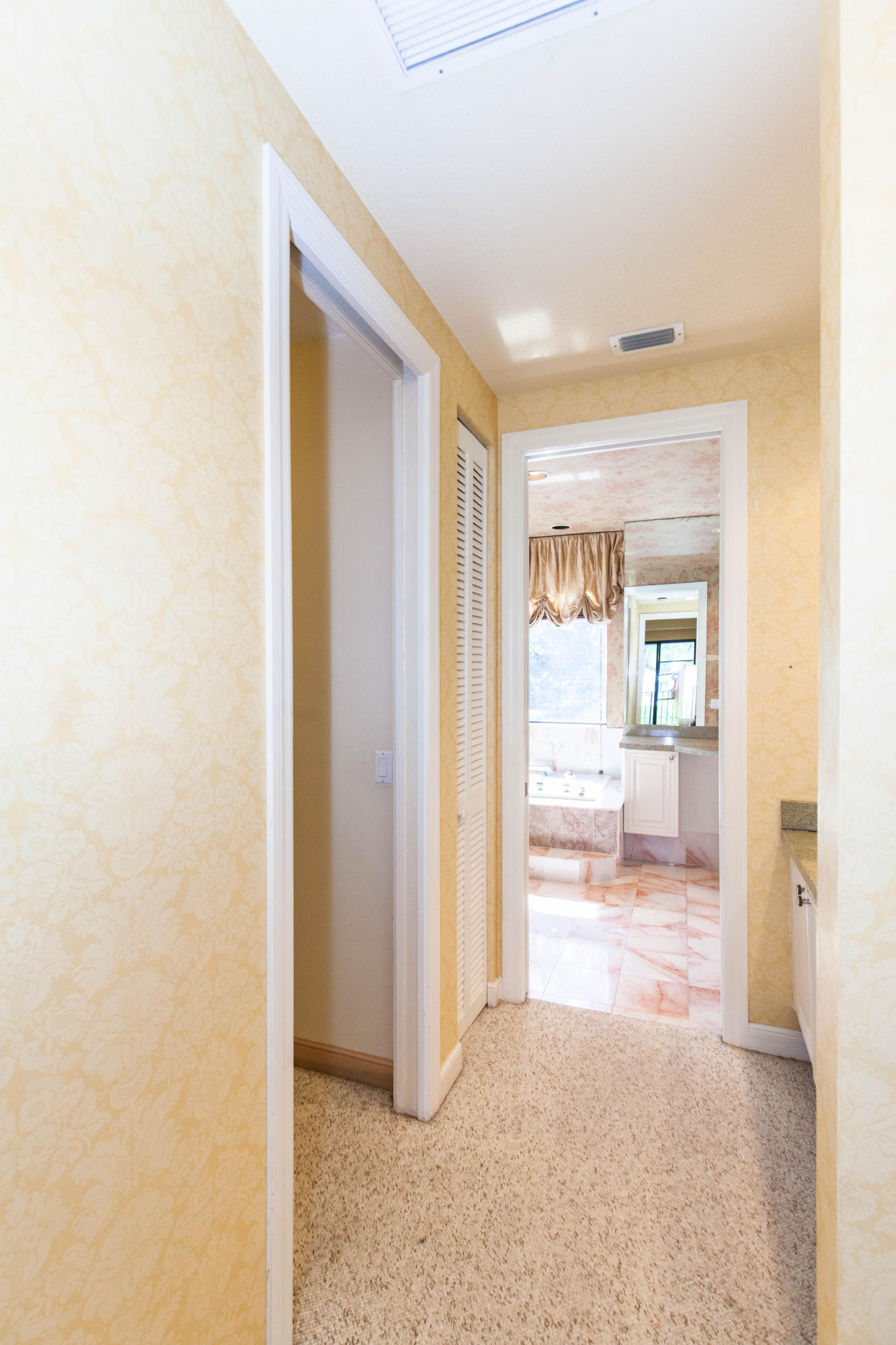 6087 Northwest 23rd Terrace Boca Raton, FL 33496 - Photo 42 of 64 a view of a hallway with wooden floor and a bathroom
