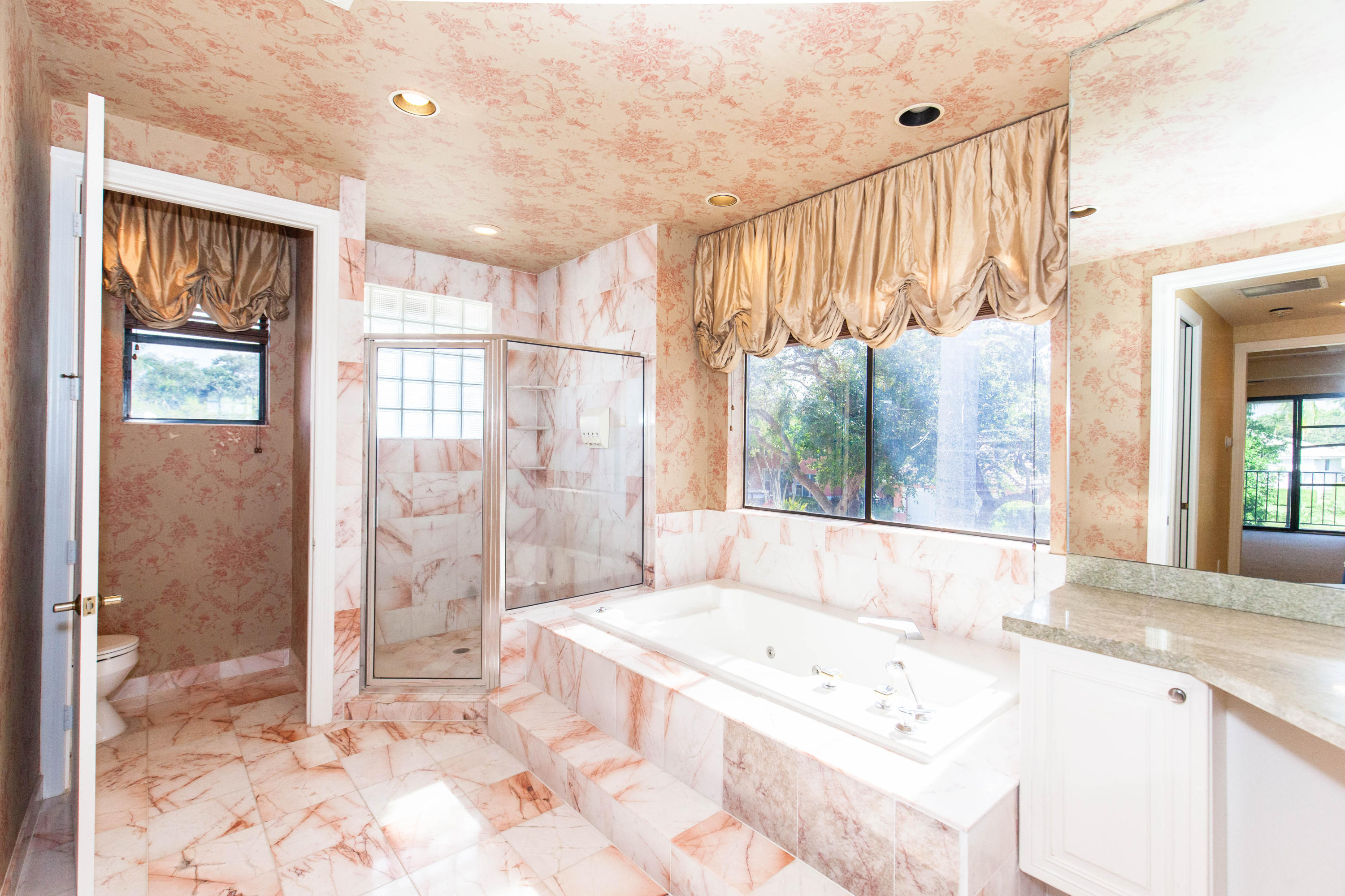 6087 Northwest 23rd Terrace Boca Raton, FL 33496 - Photo 43 of 64 a spacious bathroom with a tub sink and shower