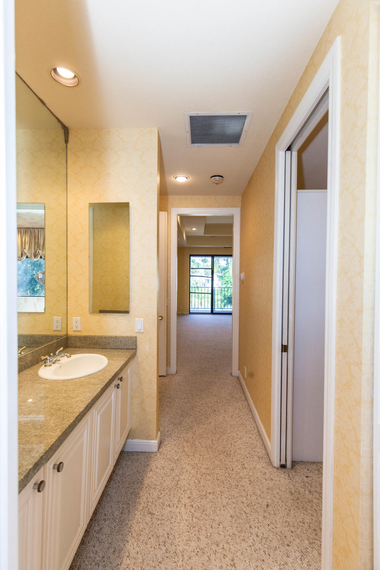 6087 Northwest 23rd Terrace Boca Raton, FL 33496 - Photo 45 of 64 a spacious bathroom with a granite countertop sink and a mirror