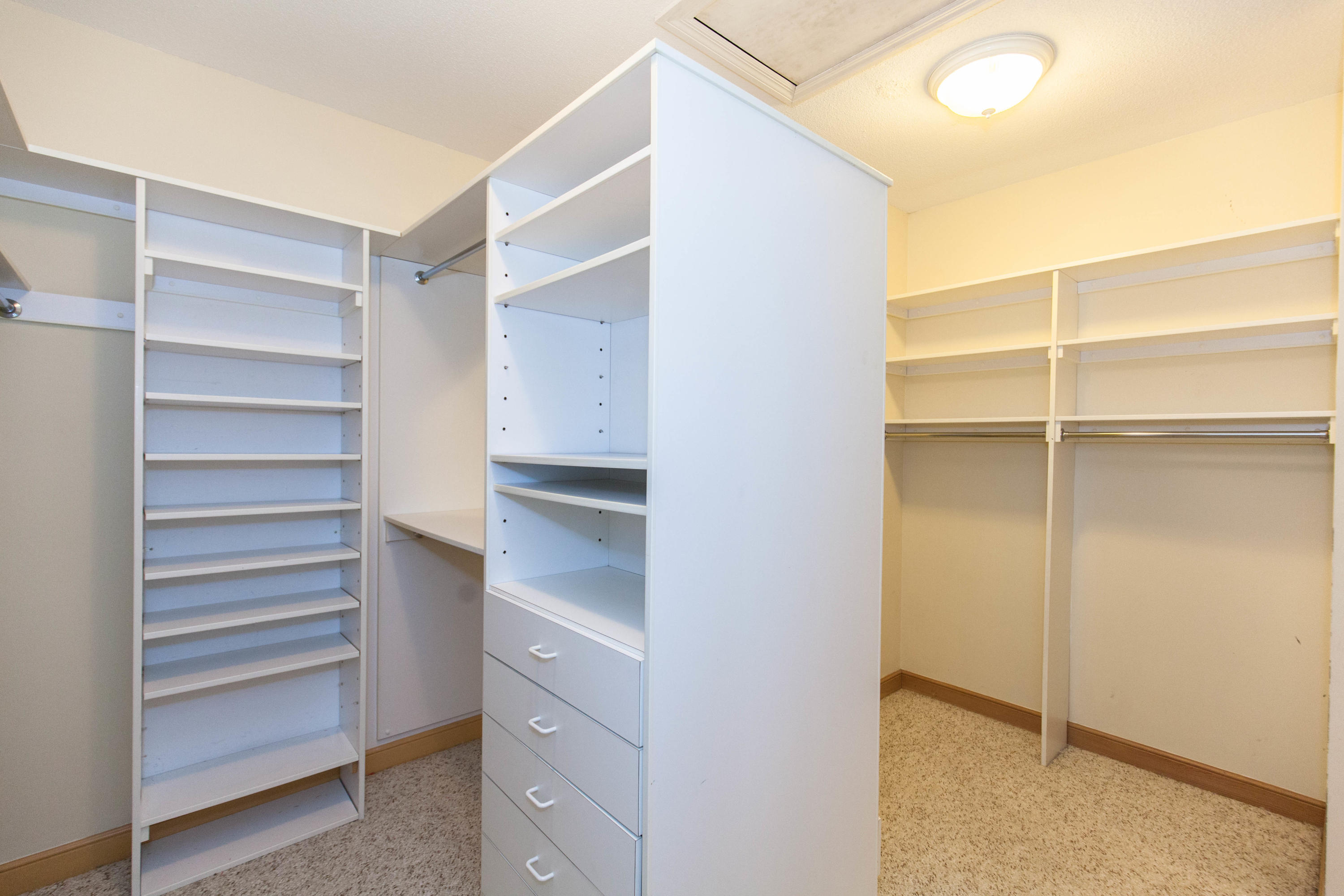 6087 Northwest 23rd Terrace Boca Raton, FL 33496 - Photo 46 of 64 a view of walk in closet with empty racks