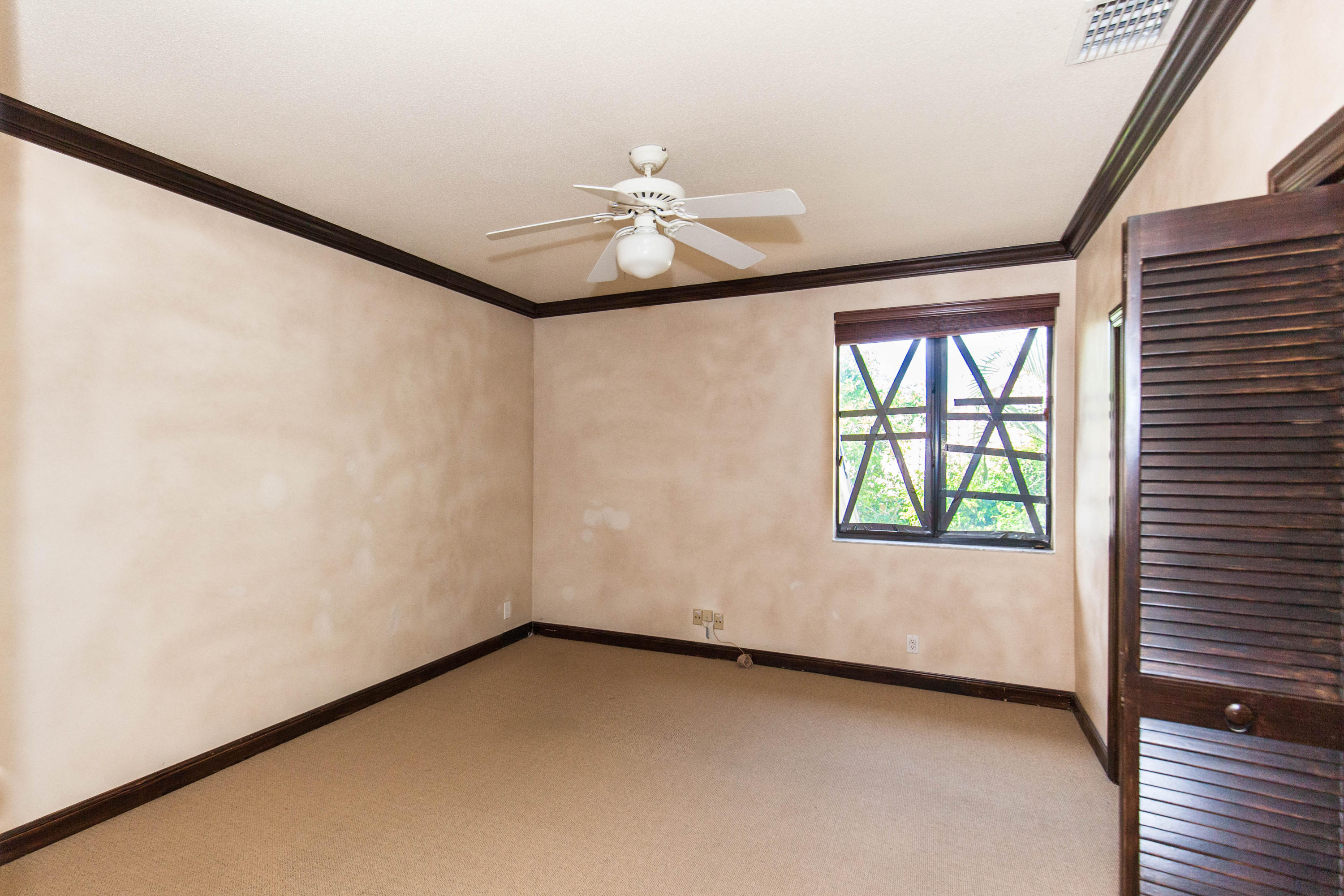 6087 Northwest 23rd Terrace Boca Raton, FL 33496 - Photo 48 of 64 en empty room with windows and ceiling fan