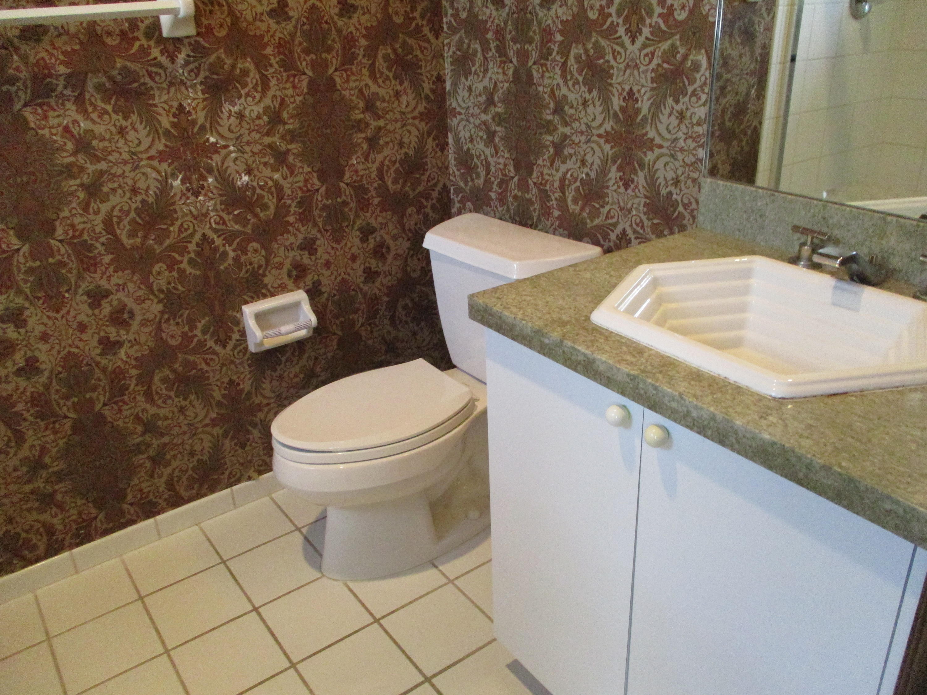 6087 Northwest 23rd Terrace Boca Raton, FL 33496 - Photo 50 of 64 a bathroom with a granite countertop toilet and a sink