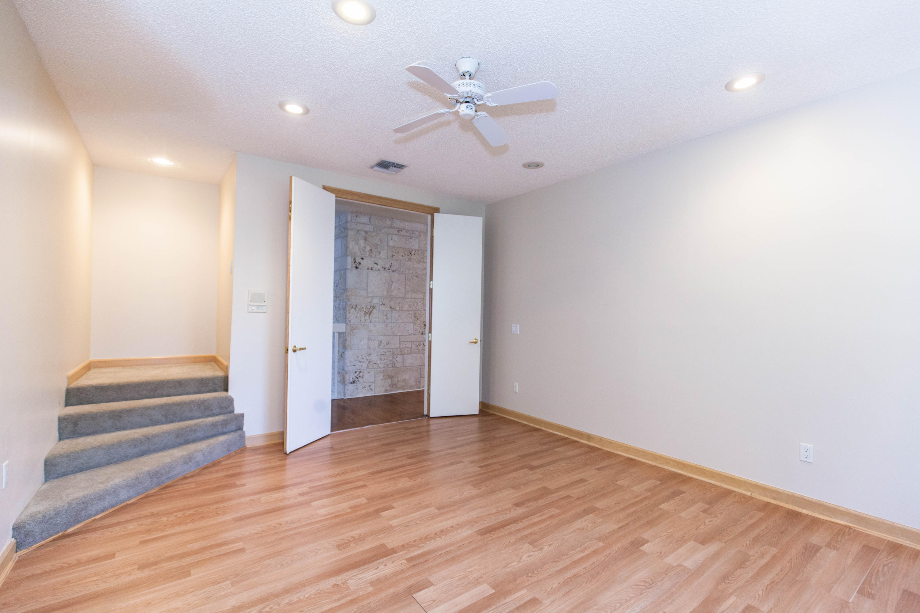 6087 Northwest 23rd Terrace Boca Raton, FL 33496 - Photo 53 of 64 wooden floor in an empty room with a ceiling fan