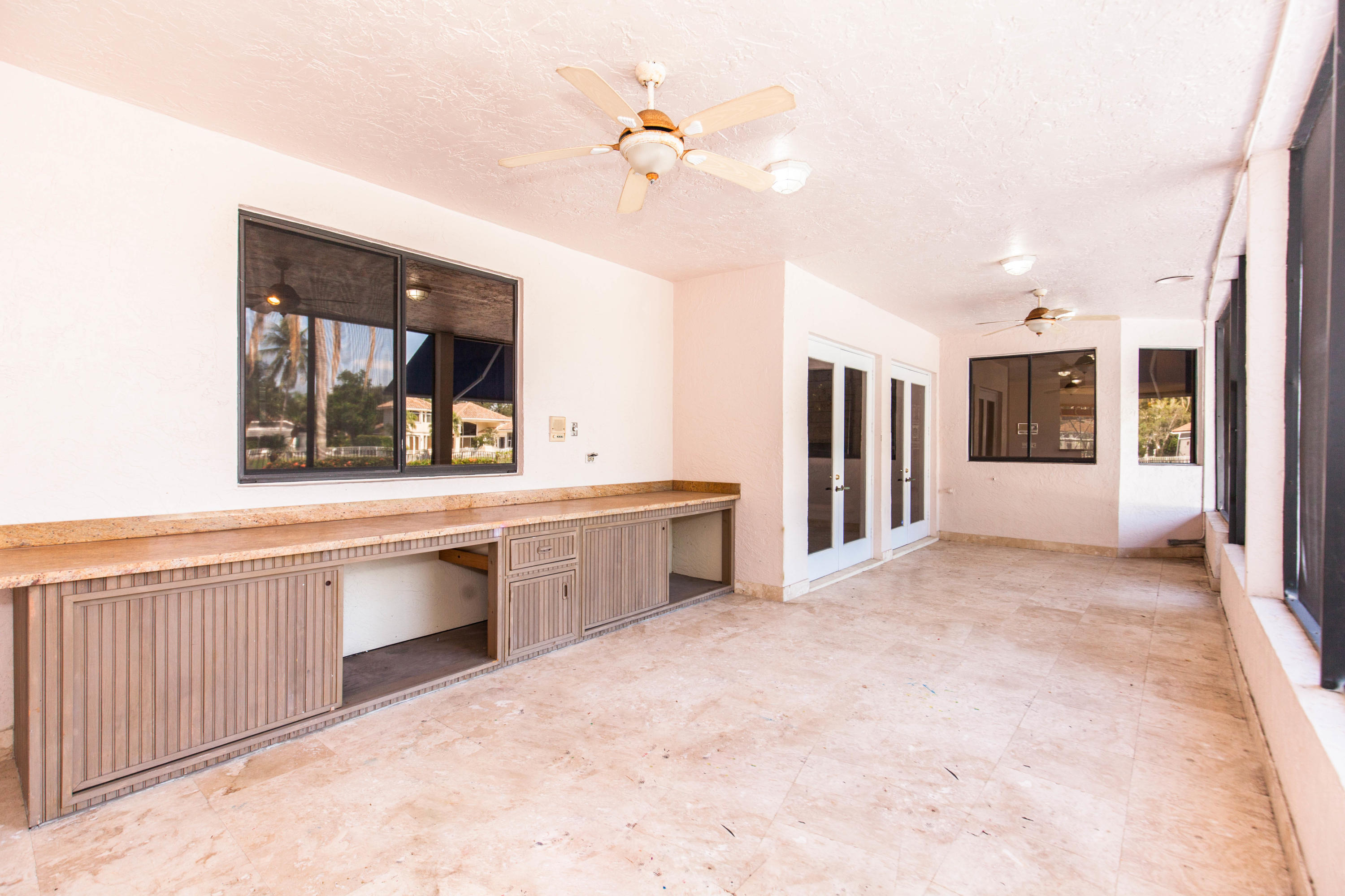 6087 Northwest 23rd Terrace Boca Raton, FL 33496 - Photo 56 of 64 a large white kitchen with sink and refrigerator