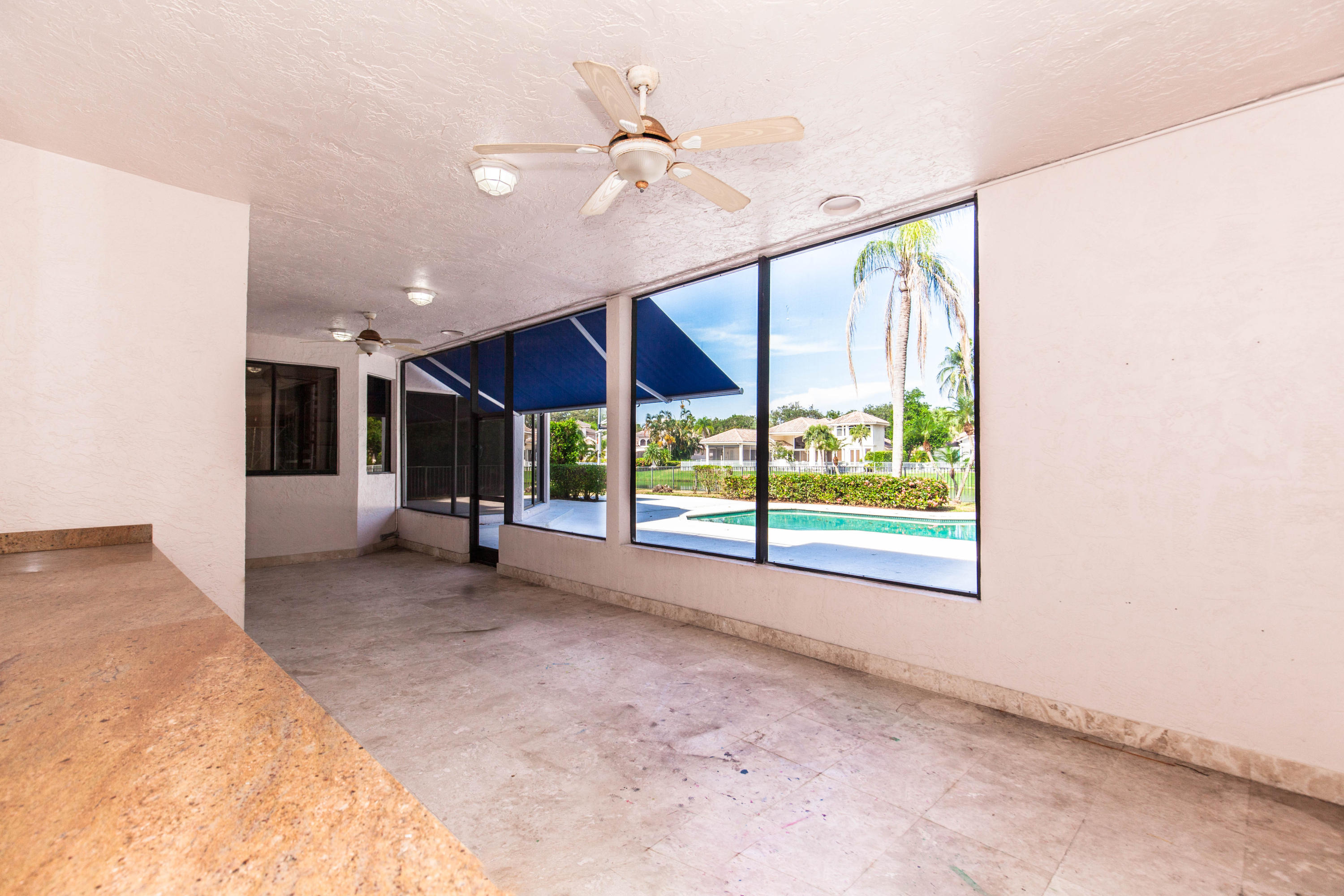 6087 Northwest 23rd Terrace Boca Raton, FL 33496 - Photo 57 of 64 a view of a room with window and a ceiling fan