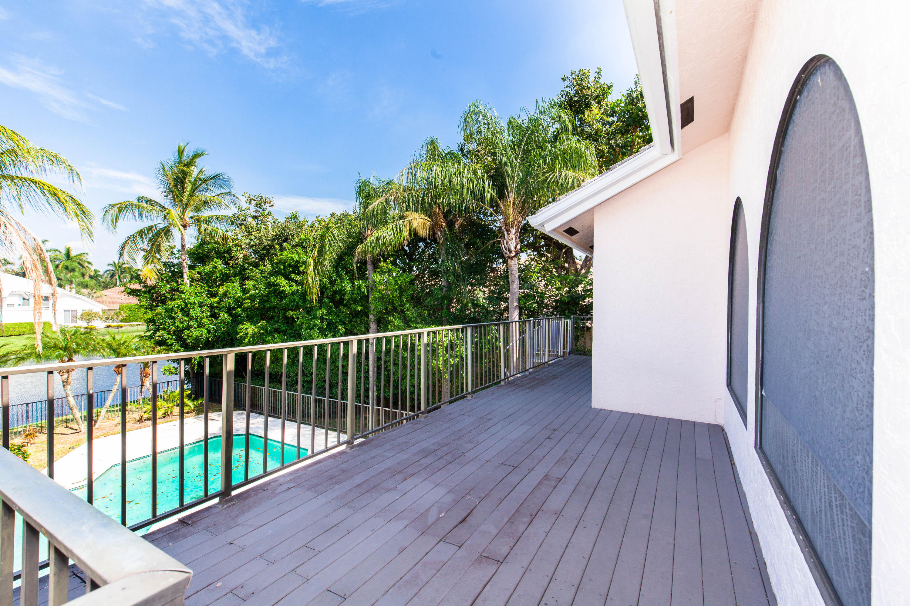 6087 Northwest 23rd Terrace Boca Raton, FL 33496 - Photo 61 of 64 a view of a balcony with wooden floor and fence