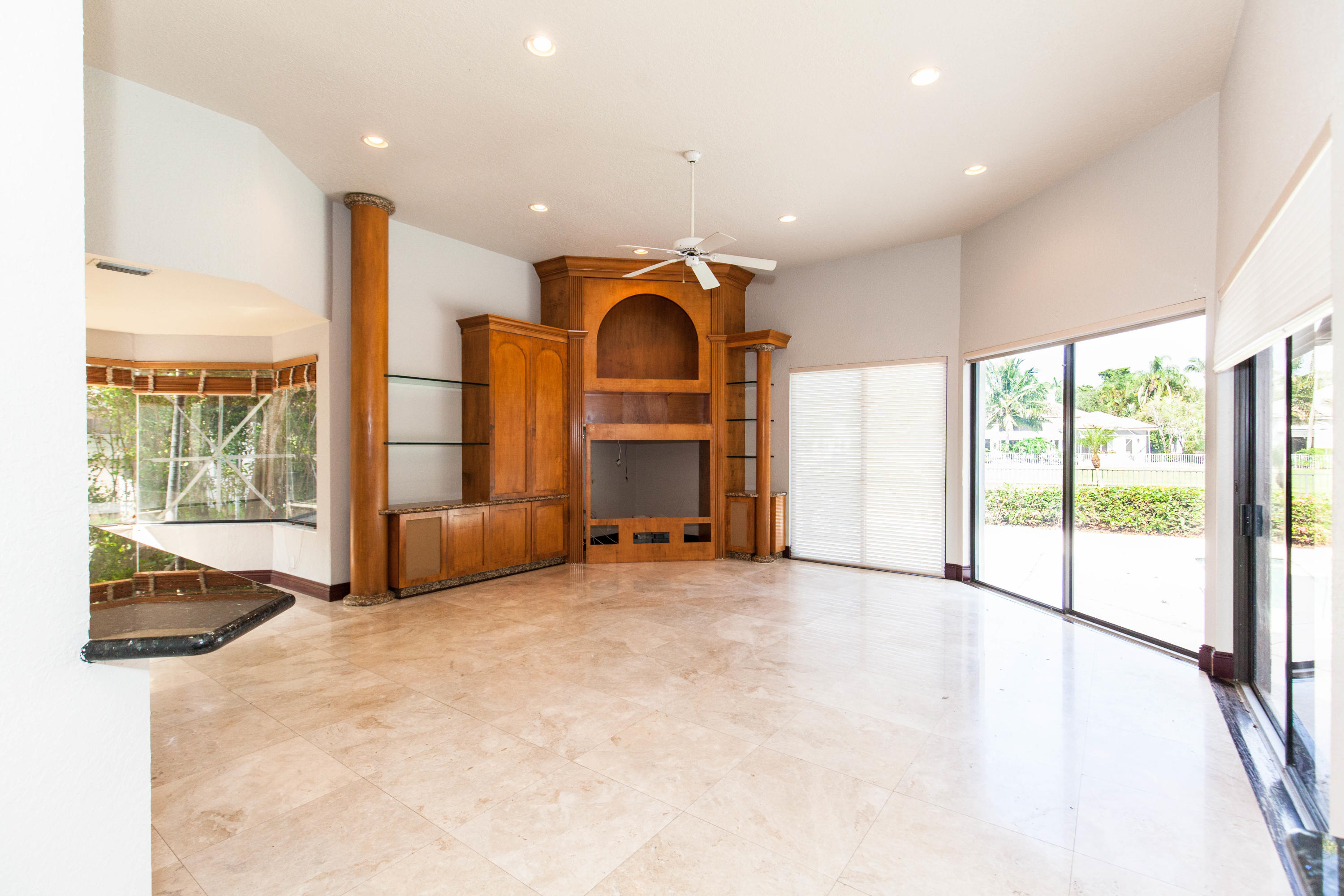 6087 Northwest 23rd Terrace Boca Raton, FL 33496 - Photo 7 of 64 a view of an empty room with a fireplace and a large window