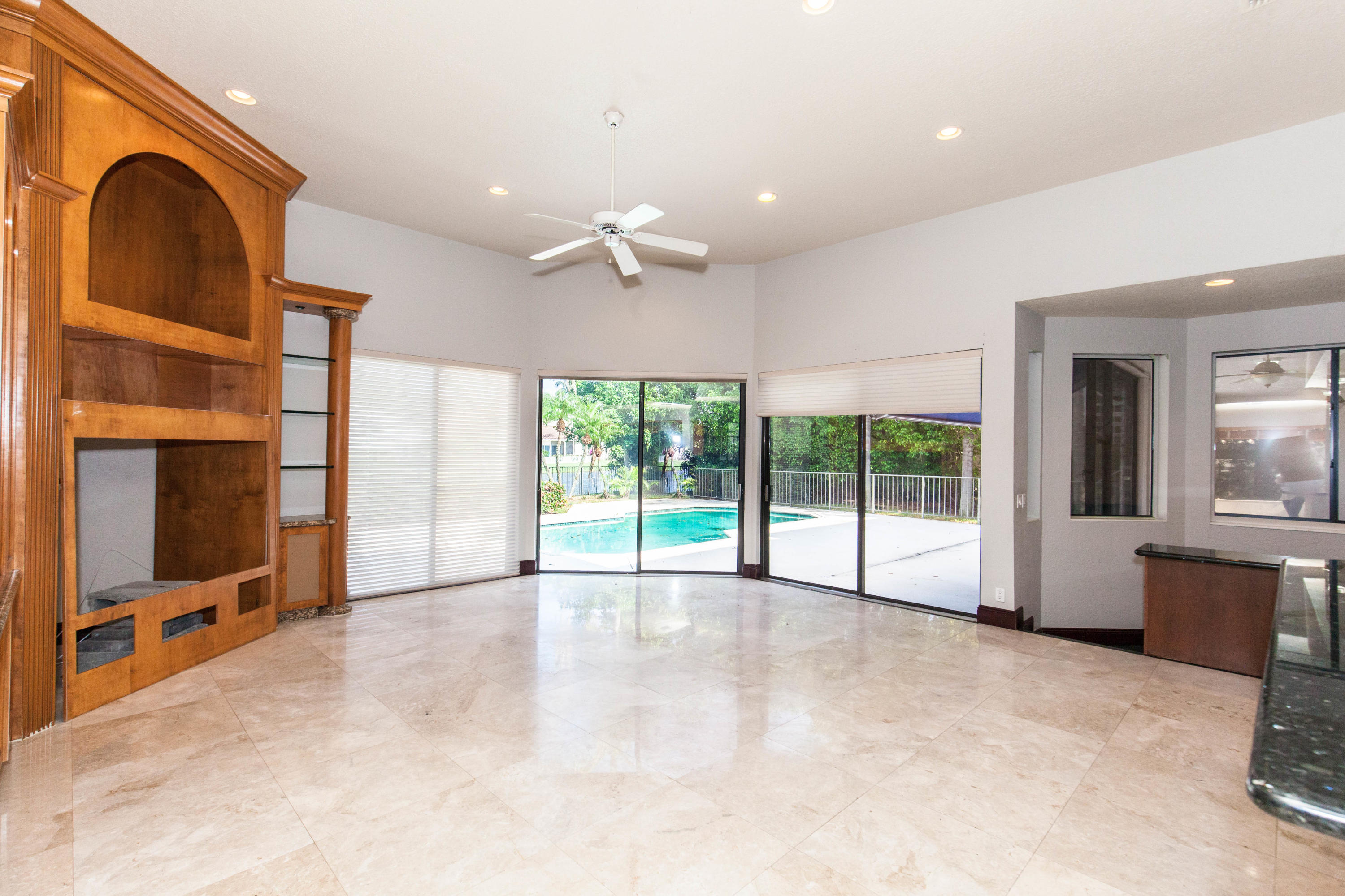 6087 Northwest 23rd Terrace Boca Raton, FL 33496 - Photo 8 of 64 a view of an empty room with a fireplace and a large window