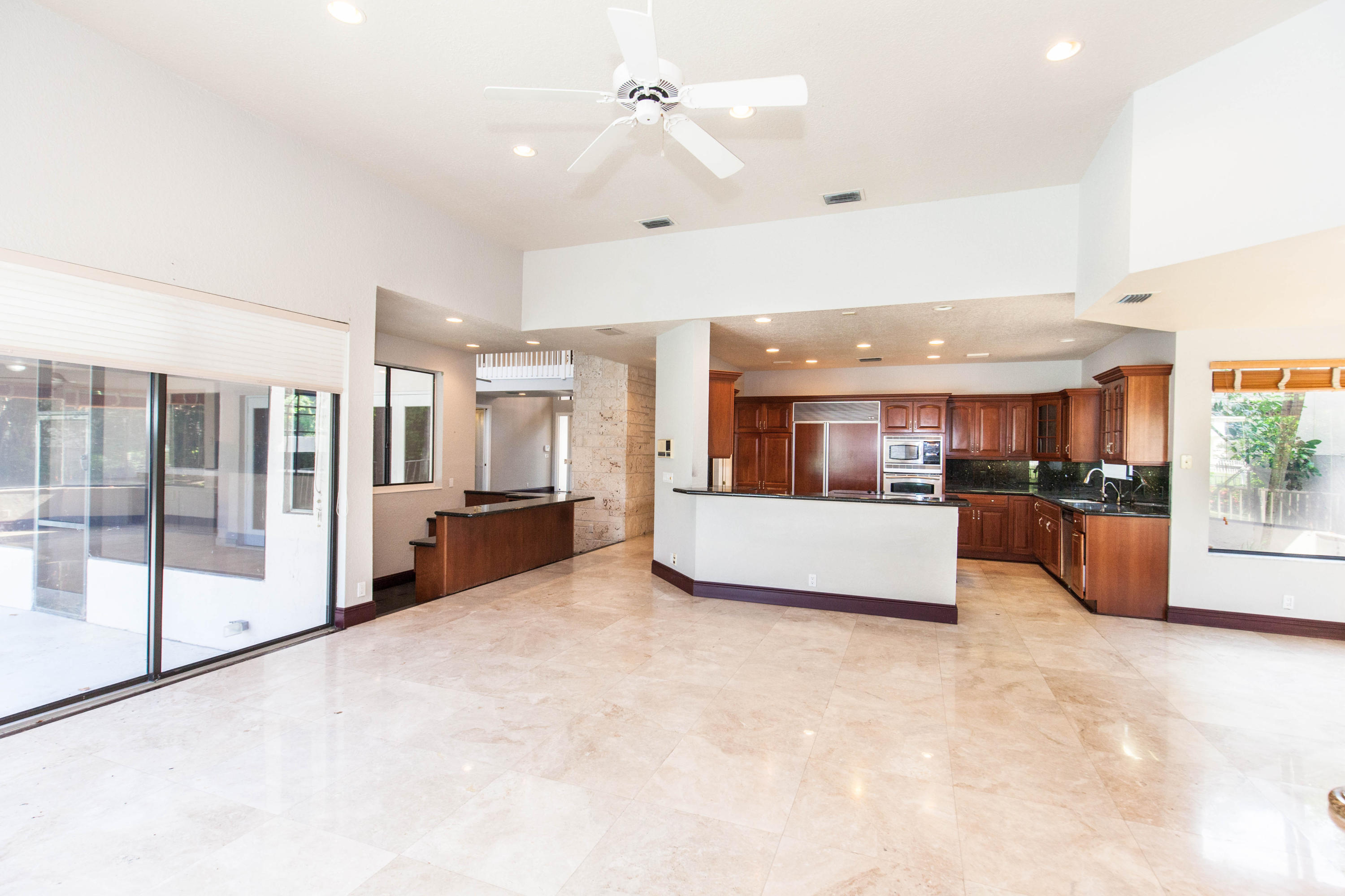 6087 Northwest 23rd Terrace Boca Raton, FL 33496 - Photo 9 of 64 a view of kitchen with furniture and large window