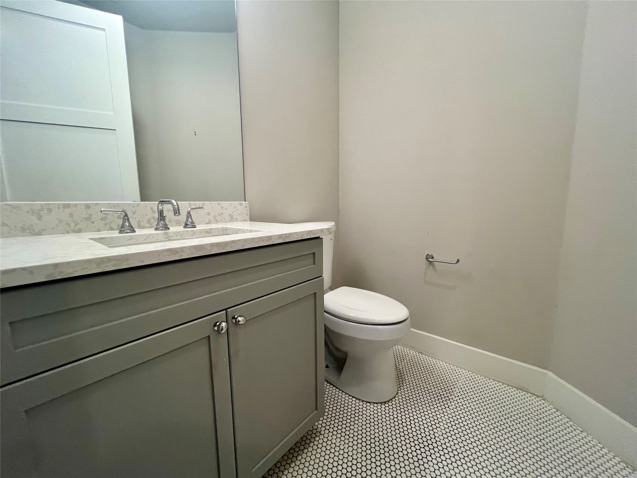 6515 Davis Lane, Unit 10 Austin, TX 78749 - Photo 9 of 22 A well-appointed powder room features a sleek vanity and classic mosaic tile flooring.