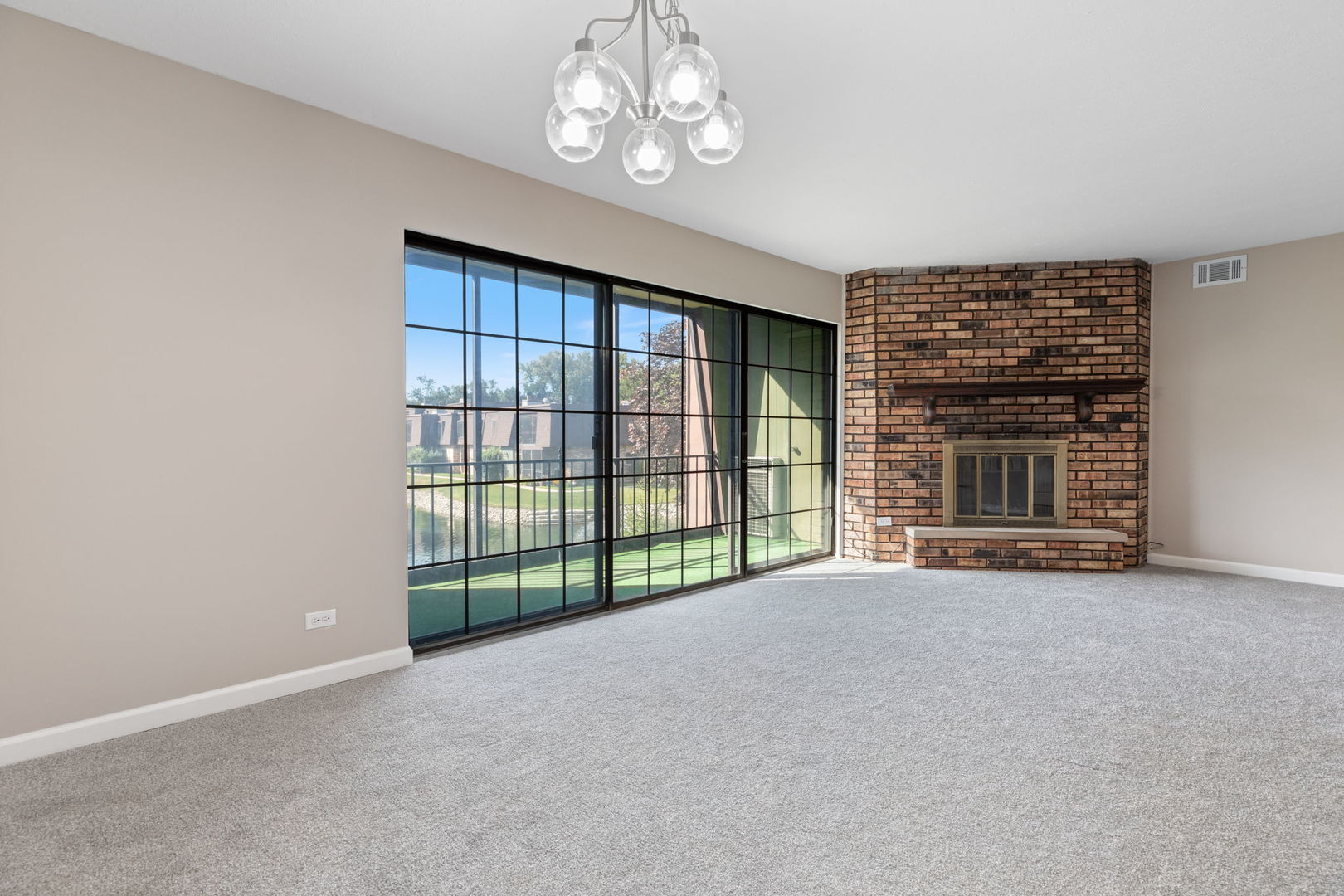 11134 NW Road, Unit 2C Palos Hills, IL 60465 - Photo 11 of 24 a view of an empty room with a fireplace and a window