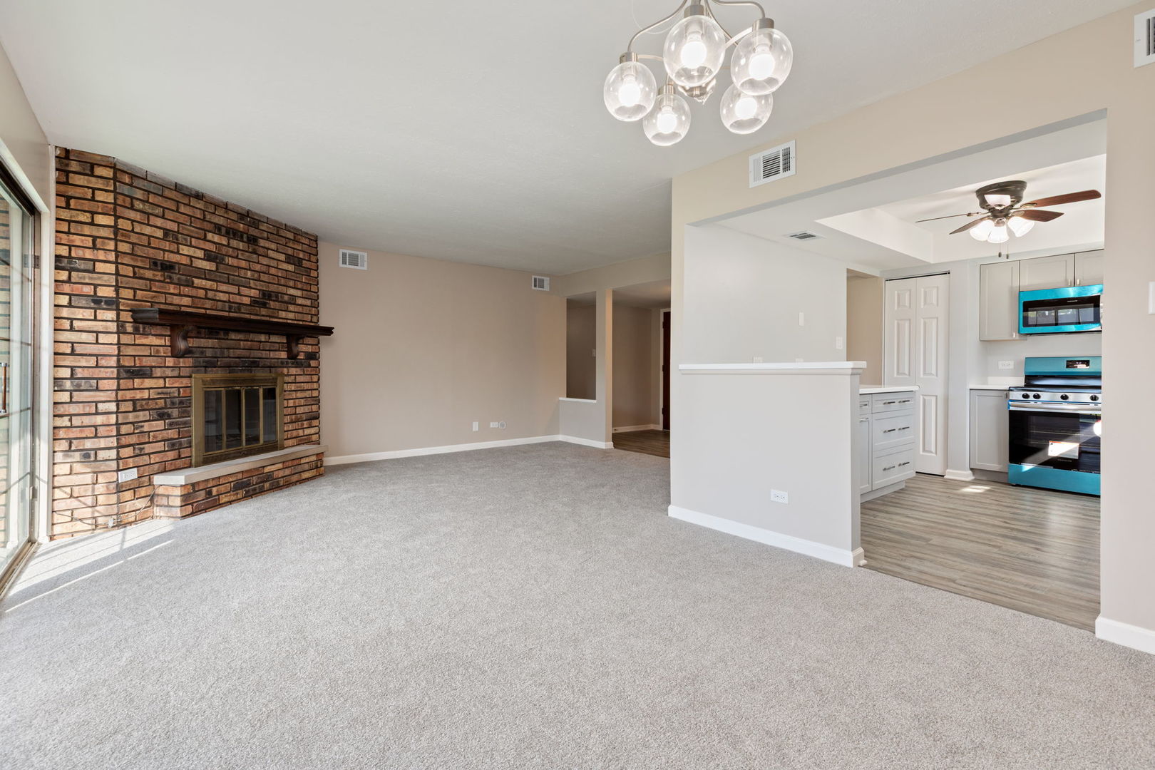 11134 NW Road, Unit 2C Palos Hills, IL 60465 - Photo 12 of 24 an empty room with a fireplace cabinet and windows
