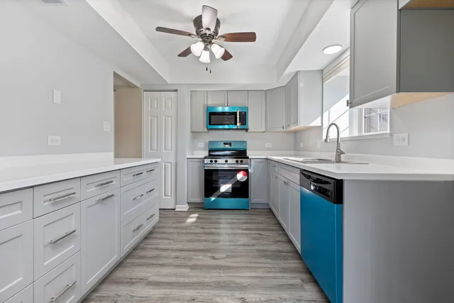 a kitchen with granite countertop a refrigerator and a sink