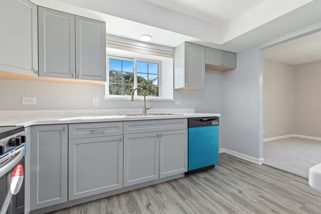 a kitchen with stainless steel appliances granite countertop a sink and wooden cabinets