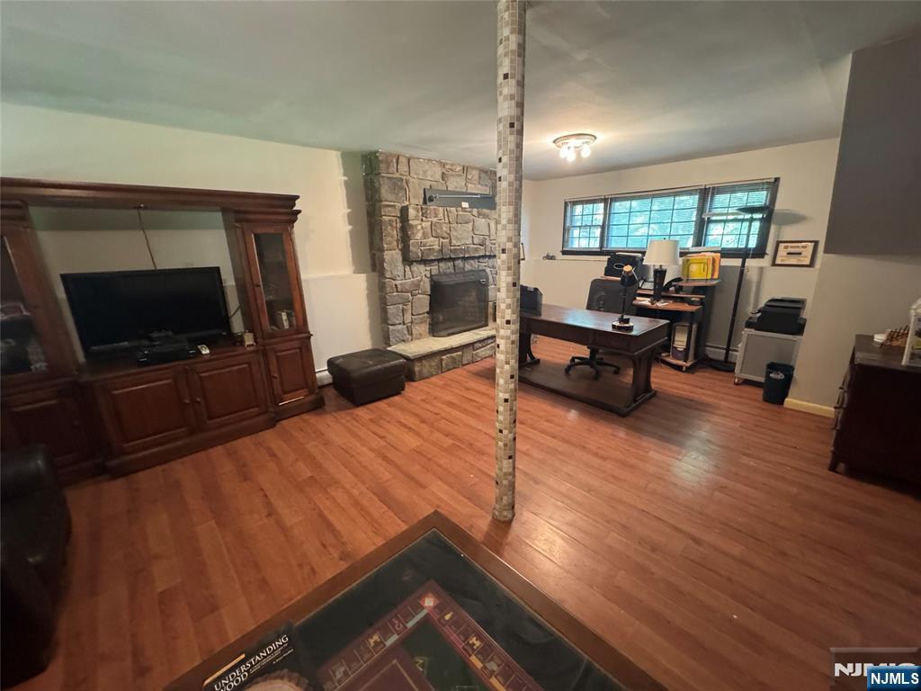 55 Maryann Road Oak Ridge, NJ 07438 - Photo 18 of 20 a living room with furniture and a flat screen tv