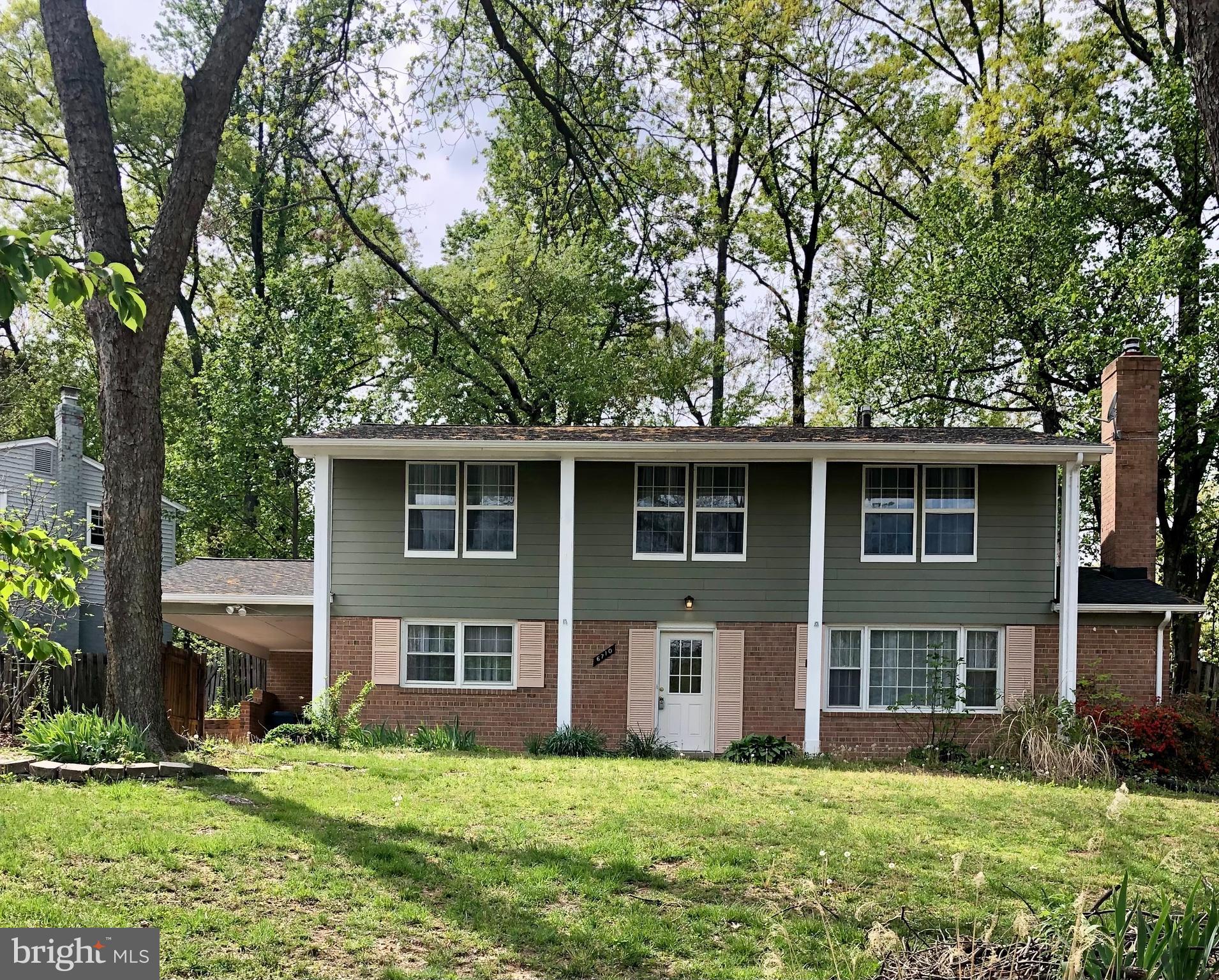 6710 Red Jacket Road Springfield, VA 22152 - Photo 1 of 53 a large house with a big yard and large trees