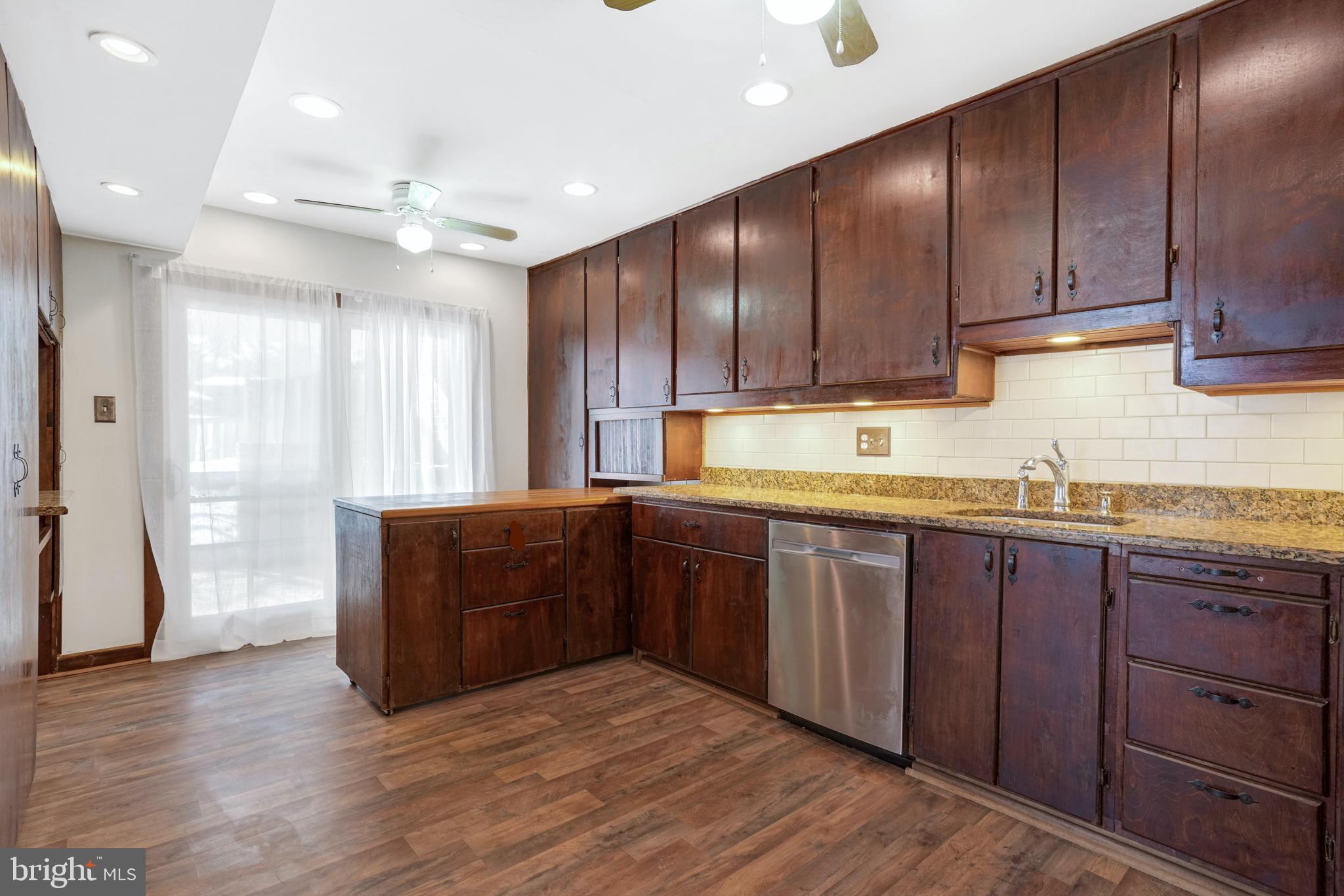 6710 Red Jacket Road Springfield, VA 22152 - Photo 18 of 53 a kitchen with granite countertop wooden cabinets a sink and dishwasher