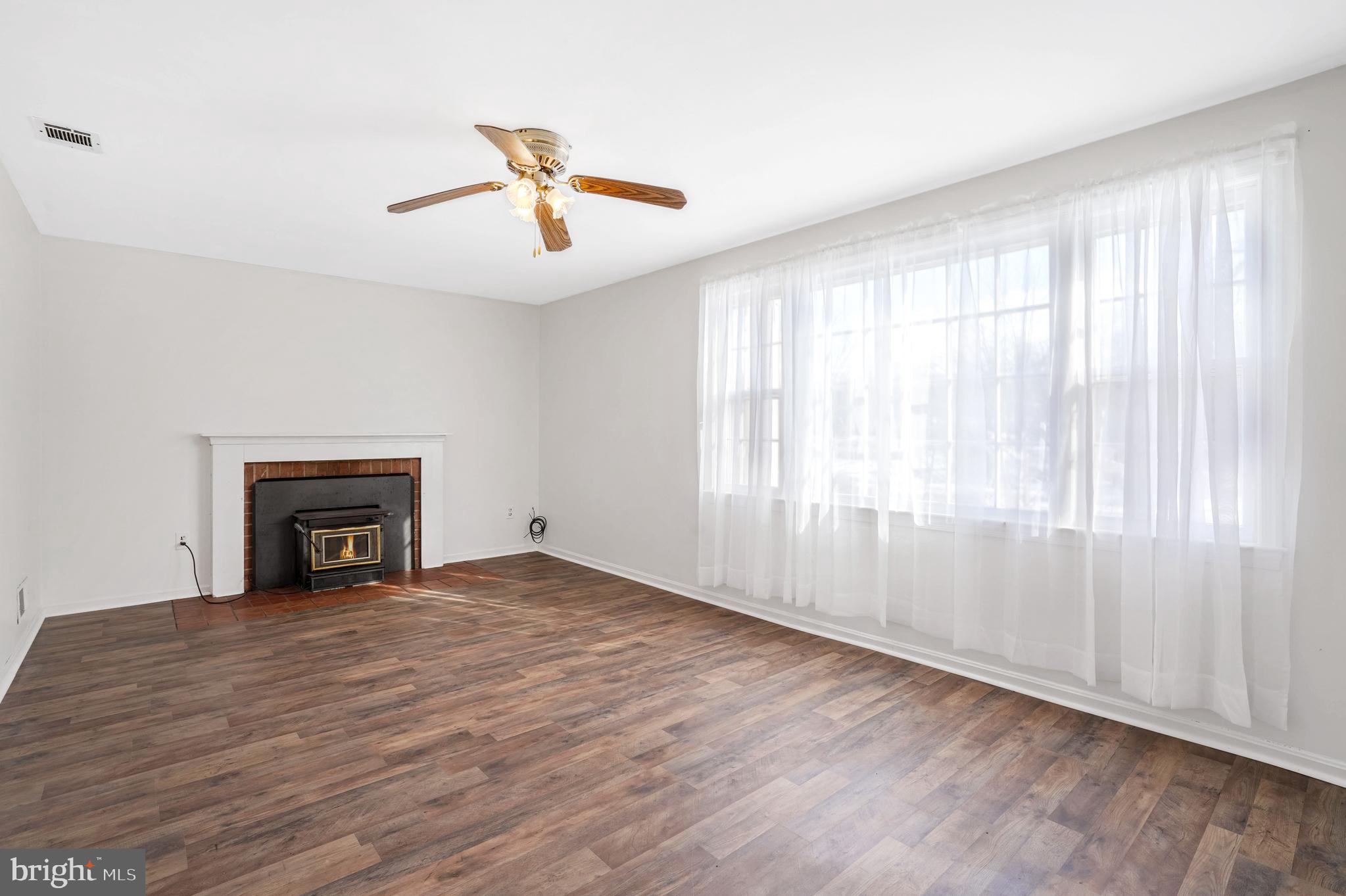 6710 Red Jacket Road Springfield, VA 22152 - Photo 2 of 53 wooden floor fireplace and windows in an empty room