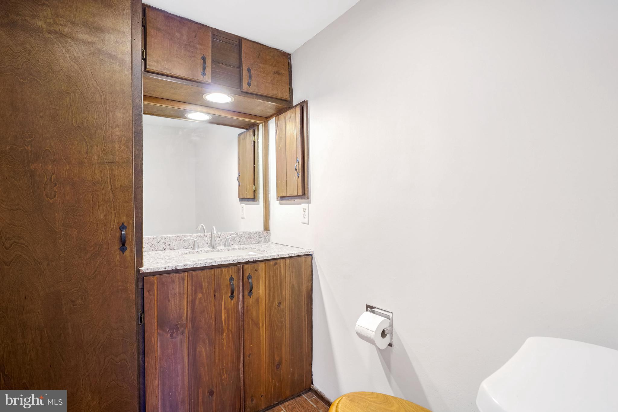 6710 Red Jacket Road Springfield, VA 22152 - Photo 21 of 53 a bathroom with a granite countertop sink mirror vanity and toilet