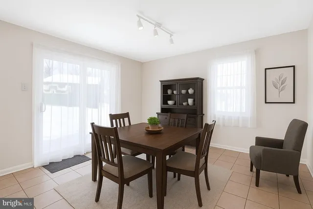 a view of a dining room with furniture and a window